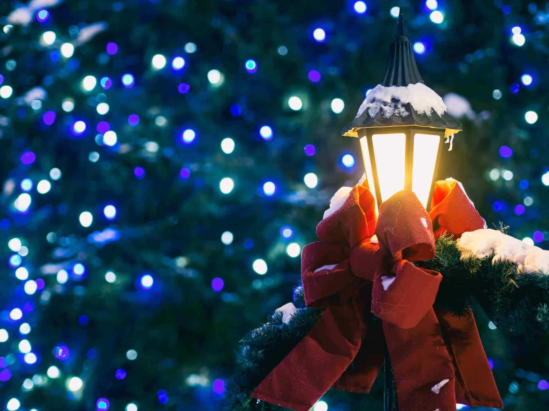 Snowy Holiday Lantern With Bokeh Lights Wallpaper