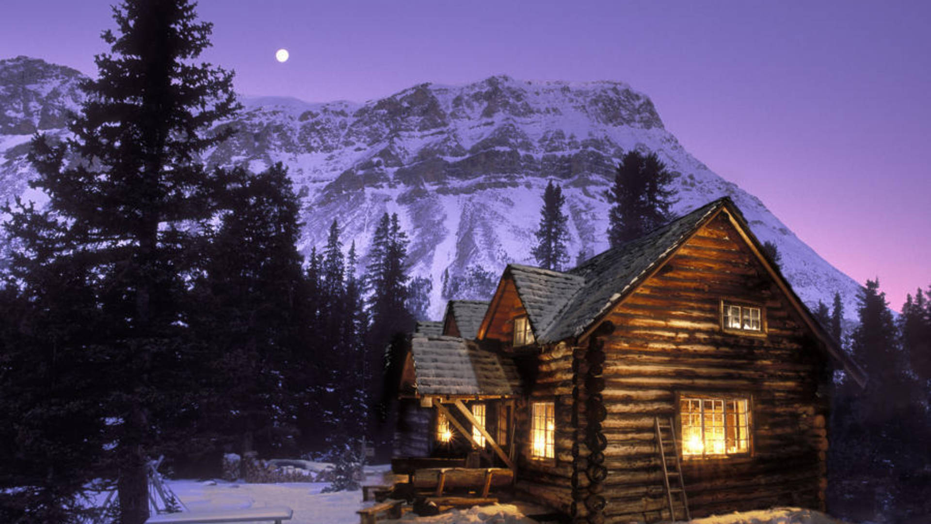 Snowy Mountain Behind Cozy Winter Cabin Wallpaper