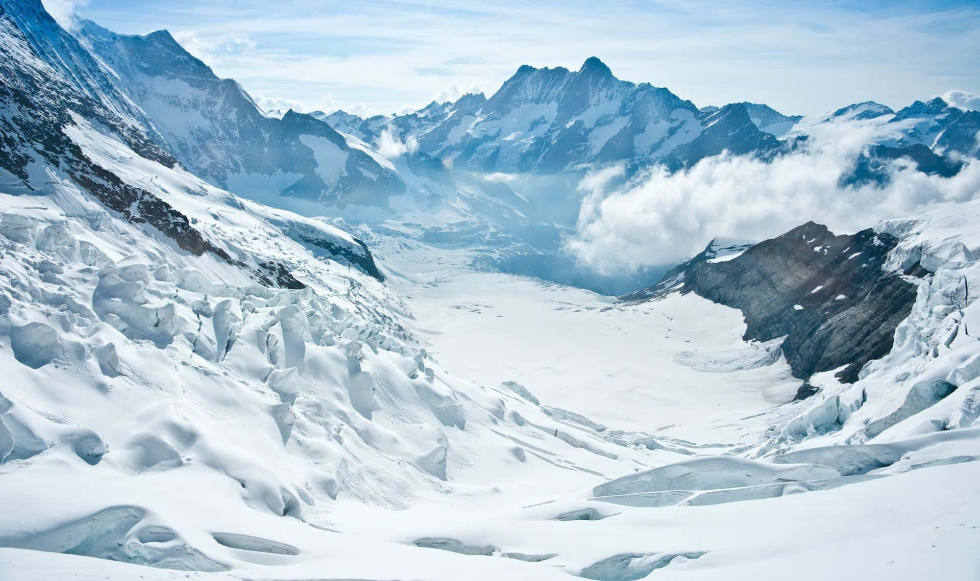 A Mountain Range With Snow Covered Mountains And Glaciers