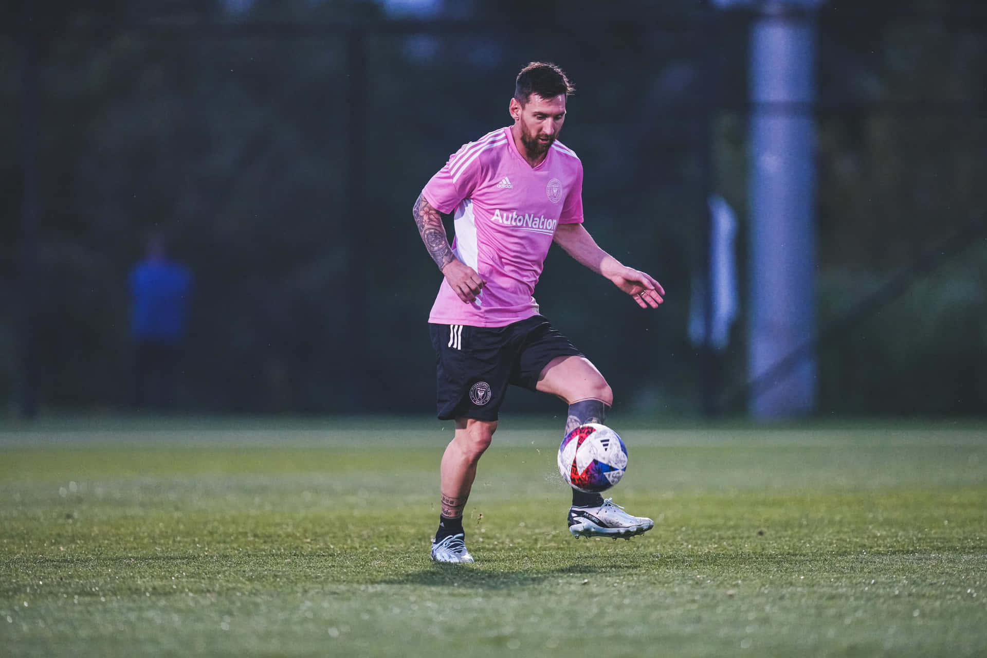 Soccer_ Player_in_ Pink_ Jersey_ Training_at_ Dusk Wallpaper