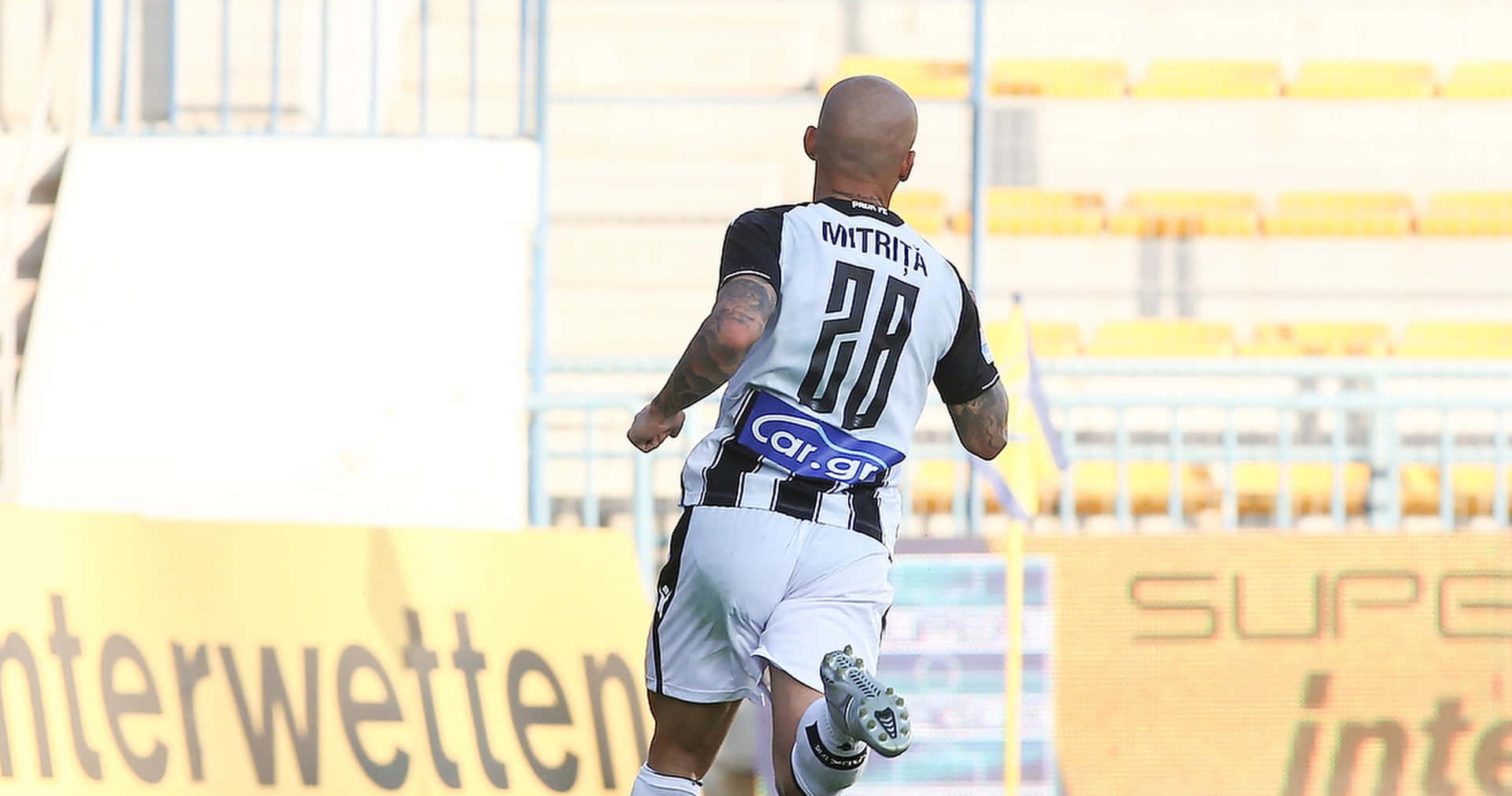 Soccer Player Mitrita Running On Field Wallpaper