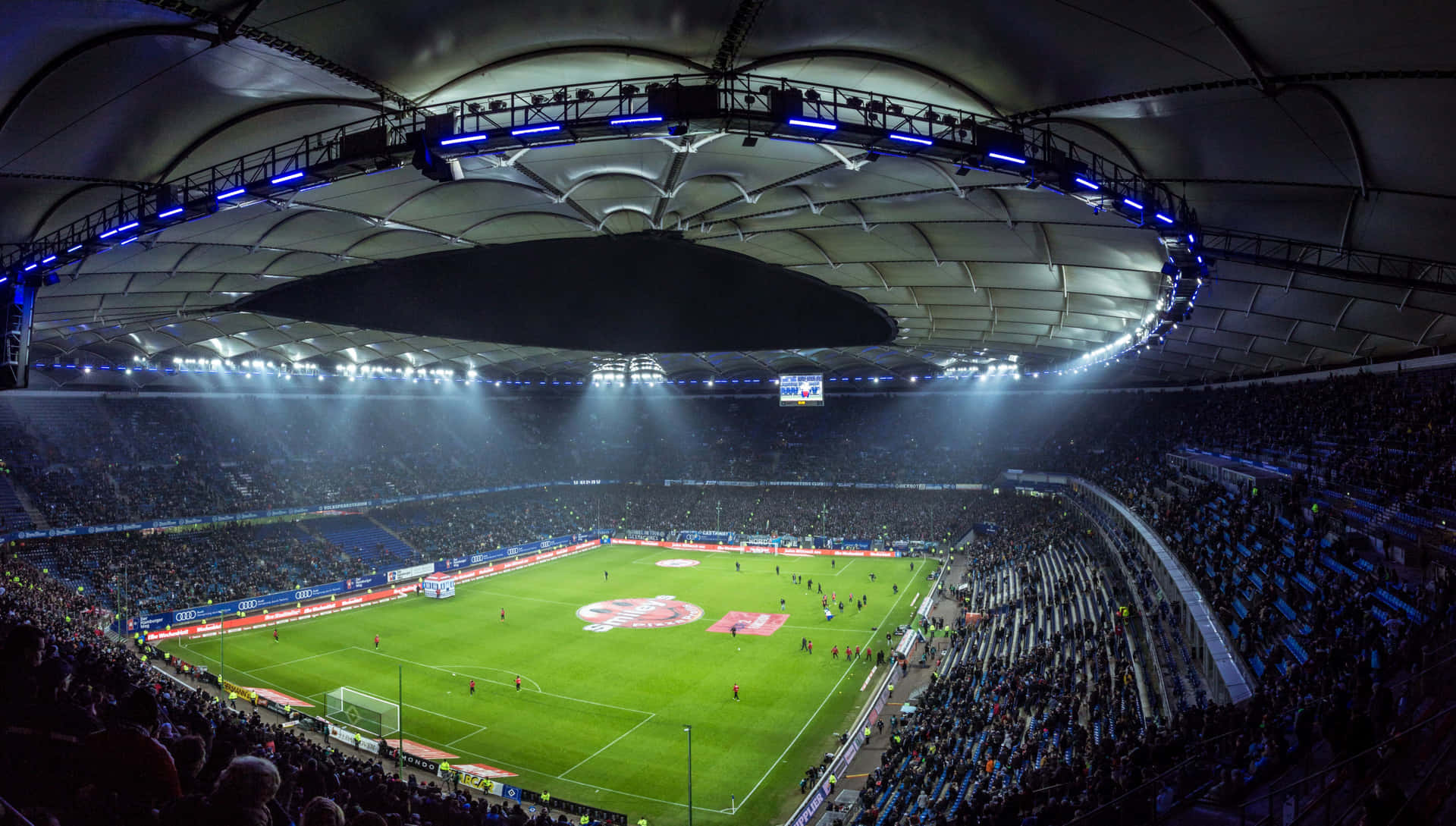 Spectacular view of a soccer stadium with bright lights at night