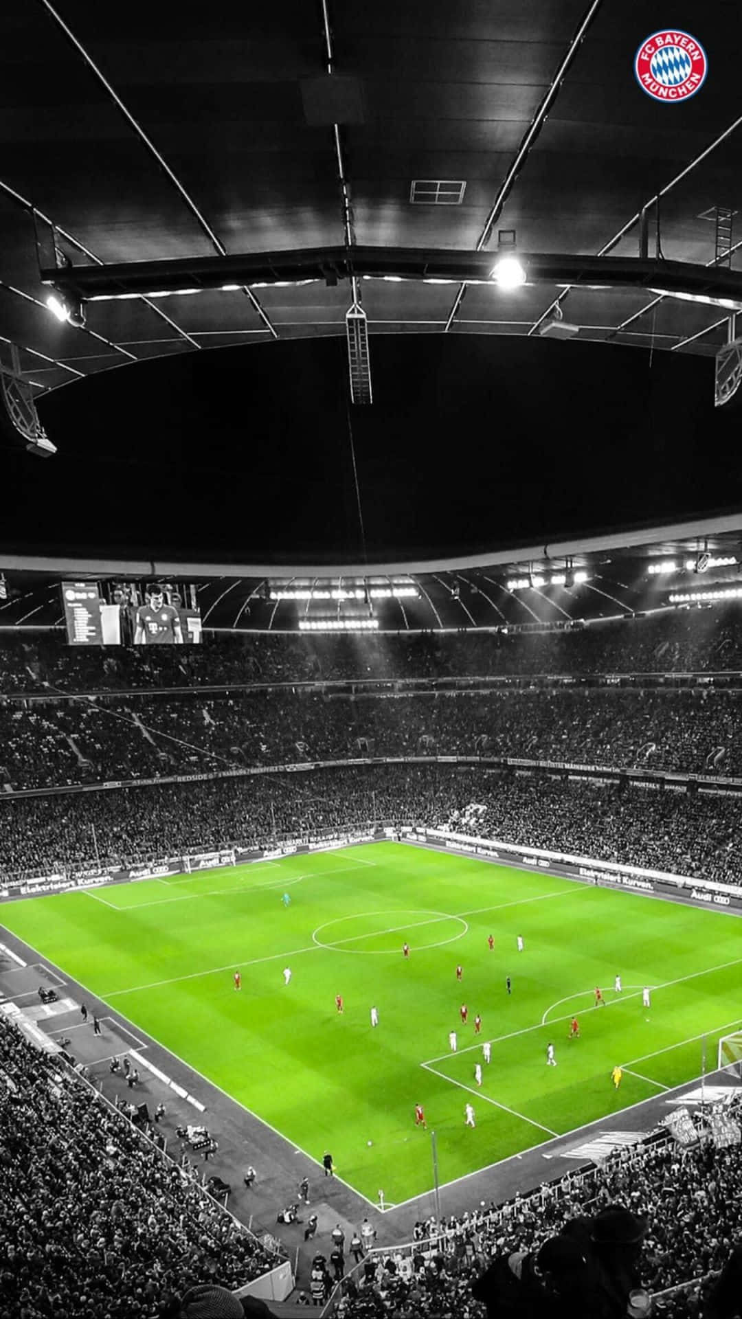 A Soccer Stadium With Lights On And A Soccer Game Wallpaper