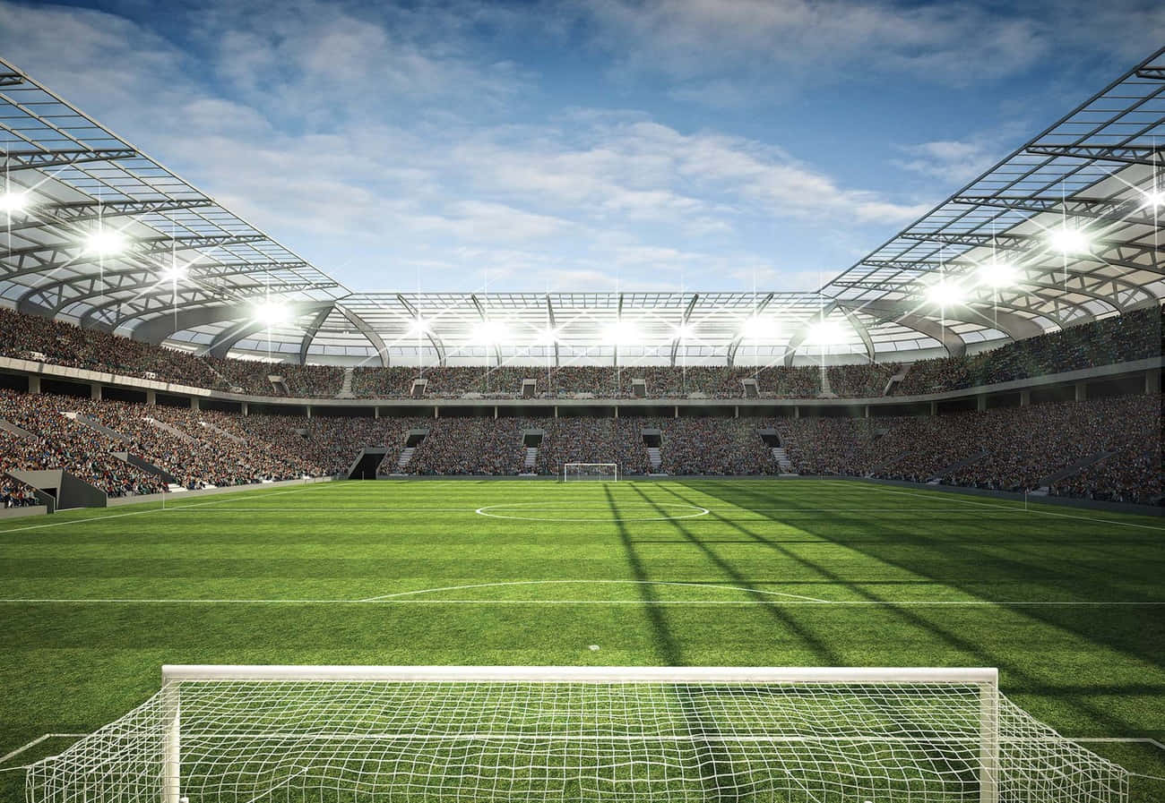 Fußballfanszeigen Ihre Leidenschaft Für Ihre Lieblingsteams In Einem Überfüllten Fußballstadion Wallpaper