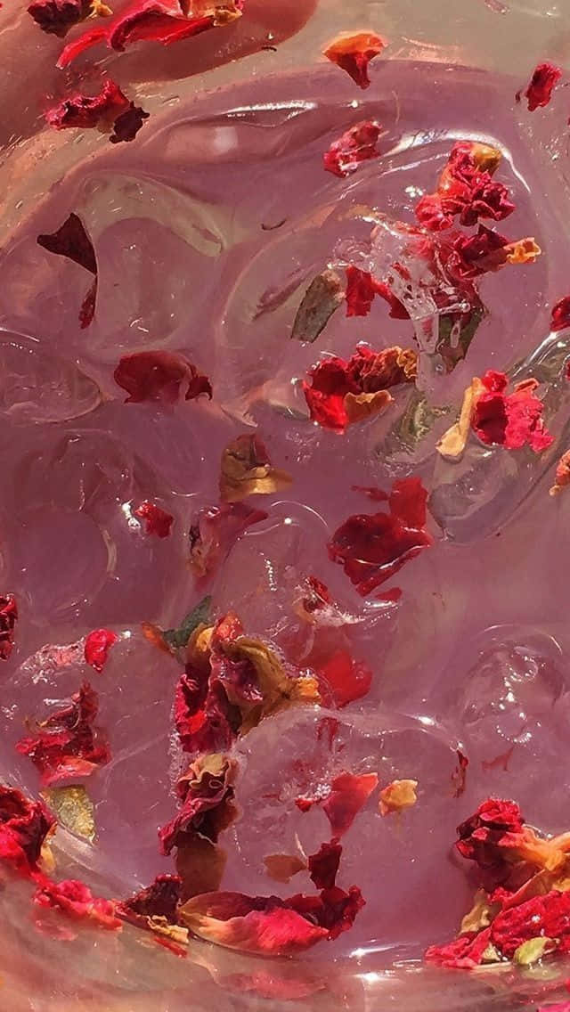 A Bowl Of Water With Rose Petals Floating In It Wallpaper