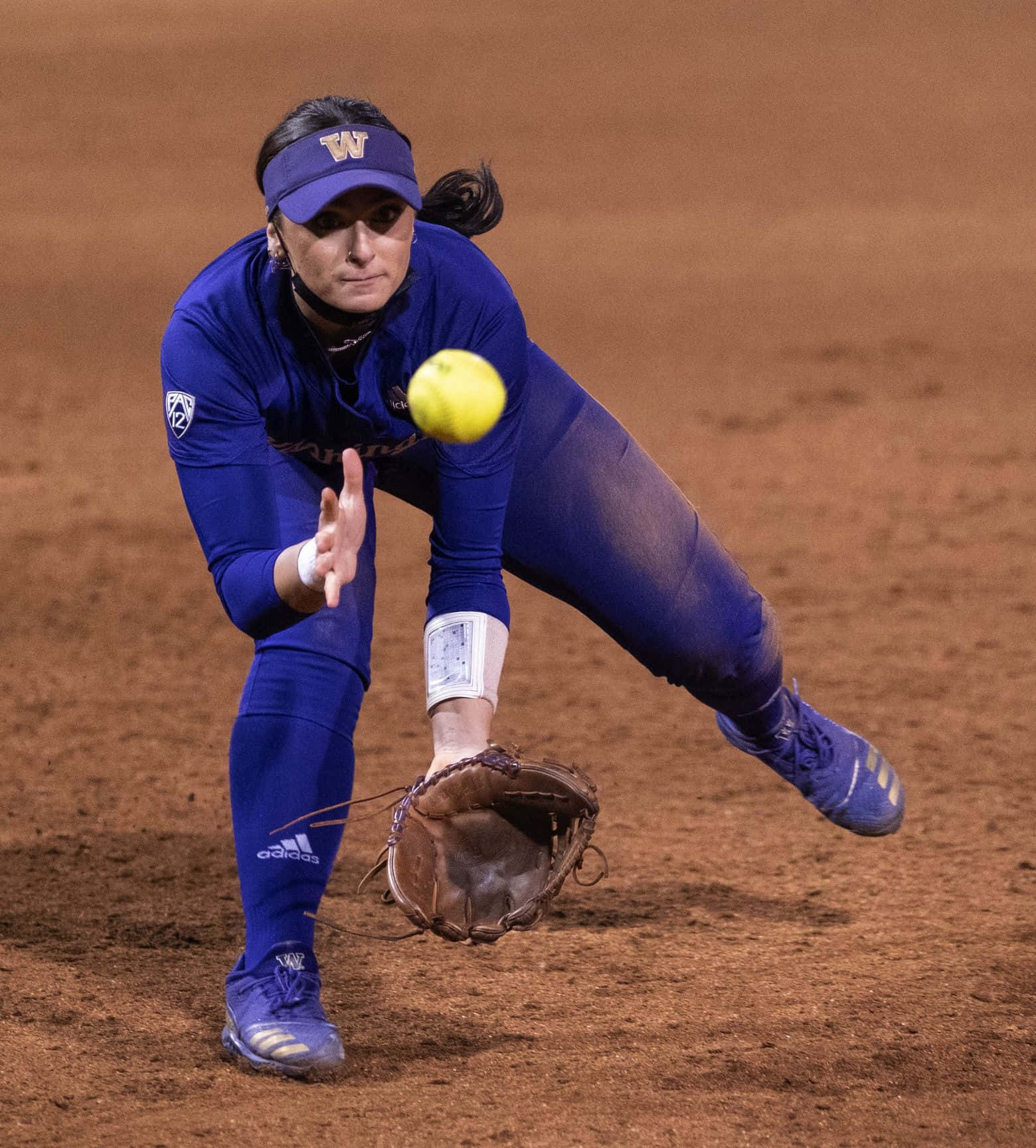 A Female Softball Player Digs Deep to Make the Play