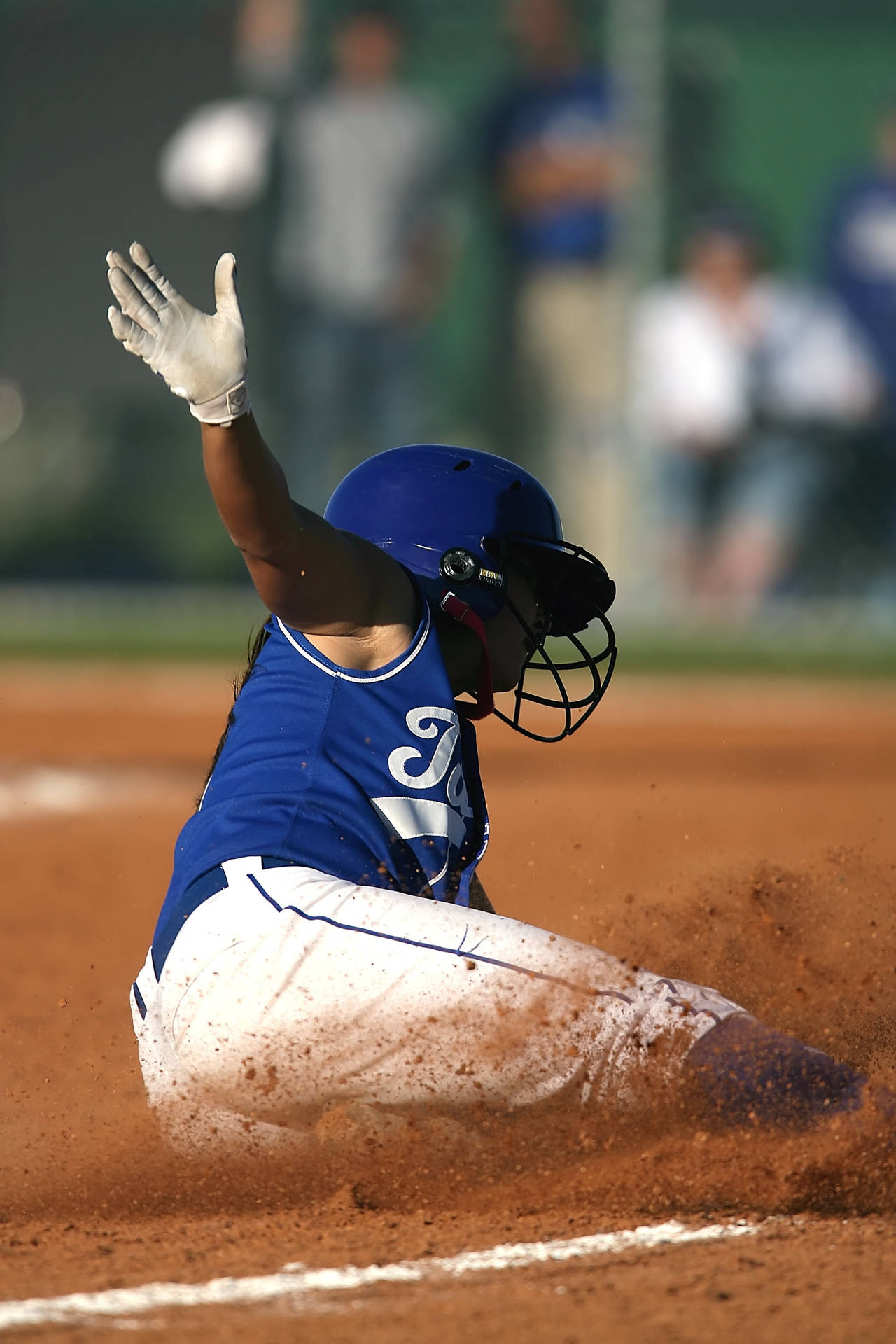 Softball Player Sliding In Playing Field Wallpaper