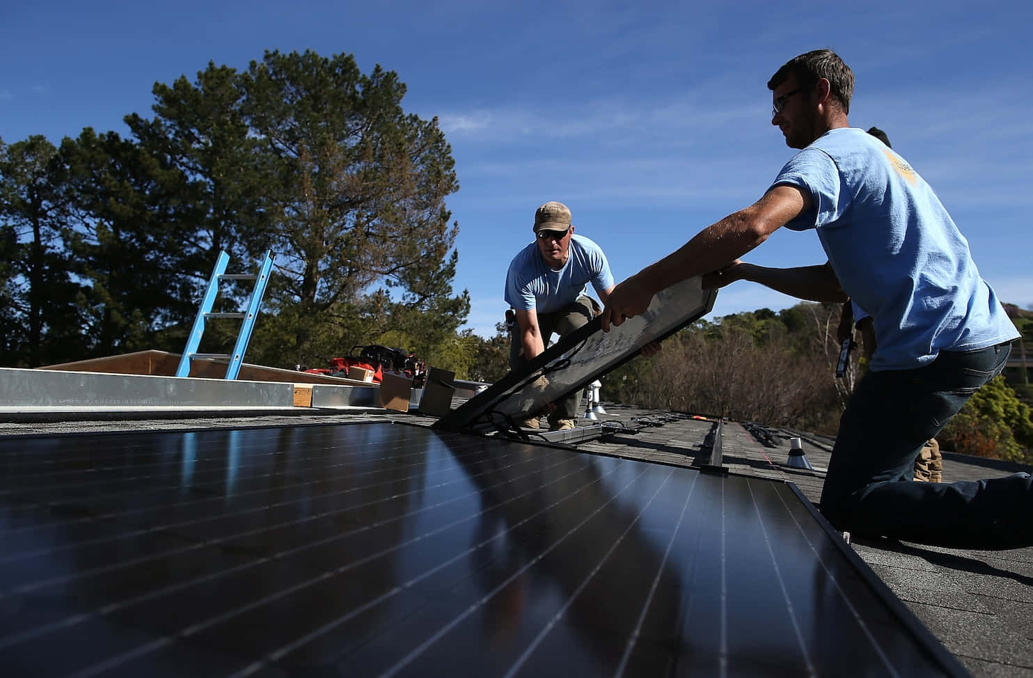 Solarcraft Workers Installing Solar Panel Wallpaper