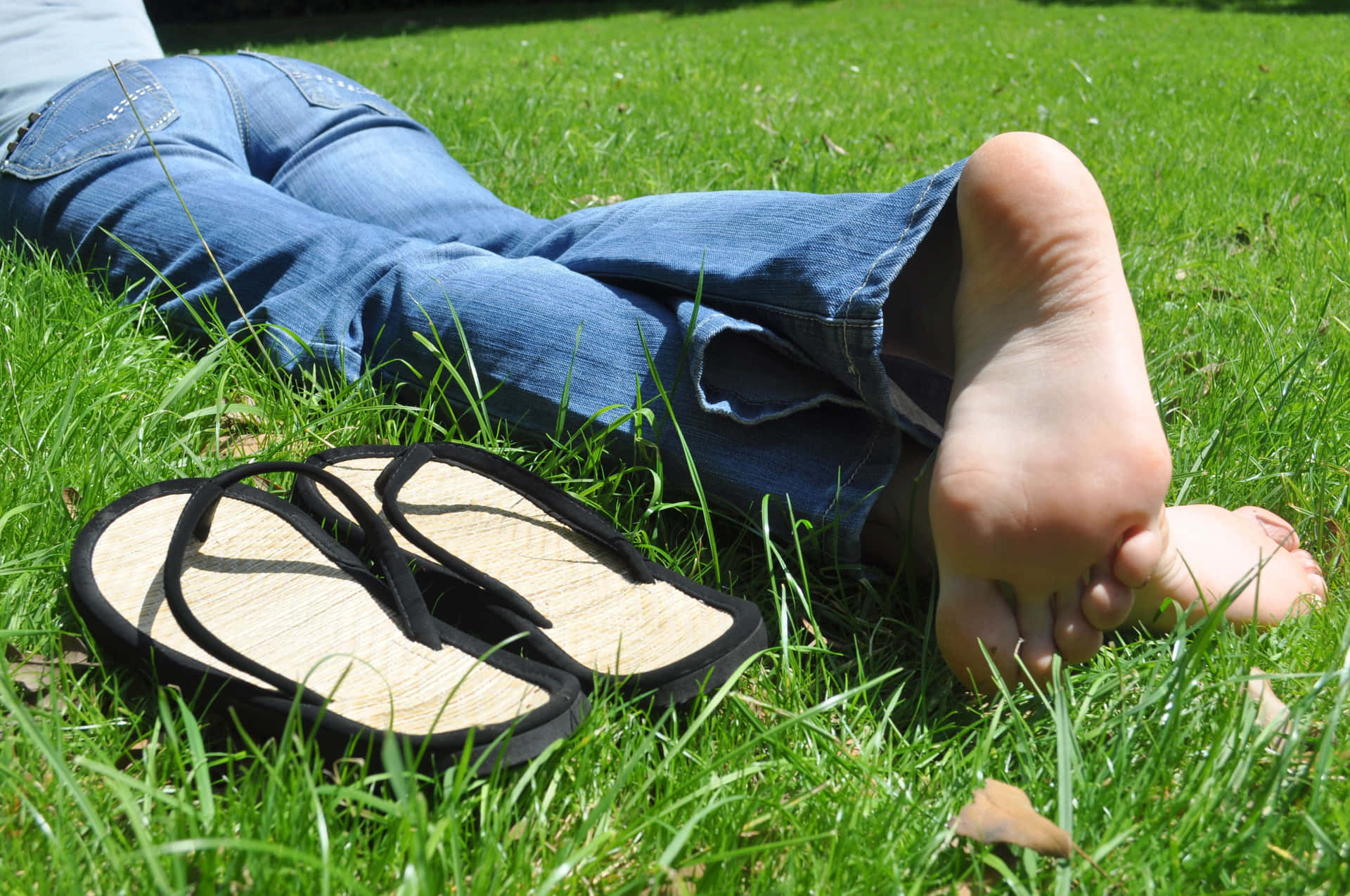 Sole Of Woman Laying On Grass Wallpaper