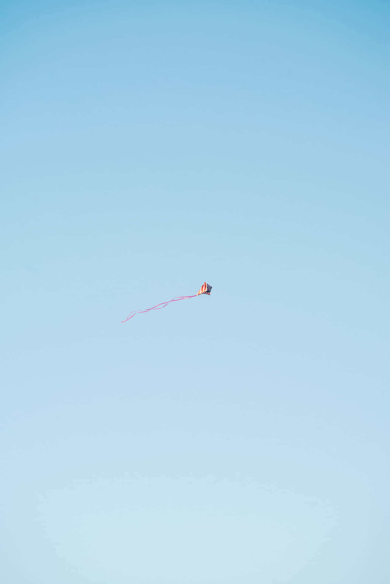 A Person Flying A Kite In The Sky