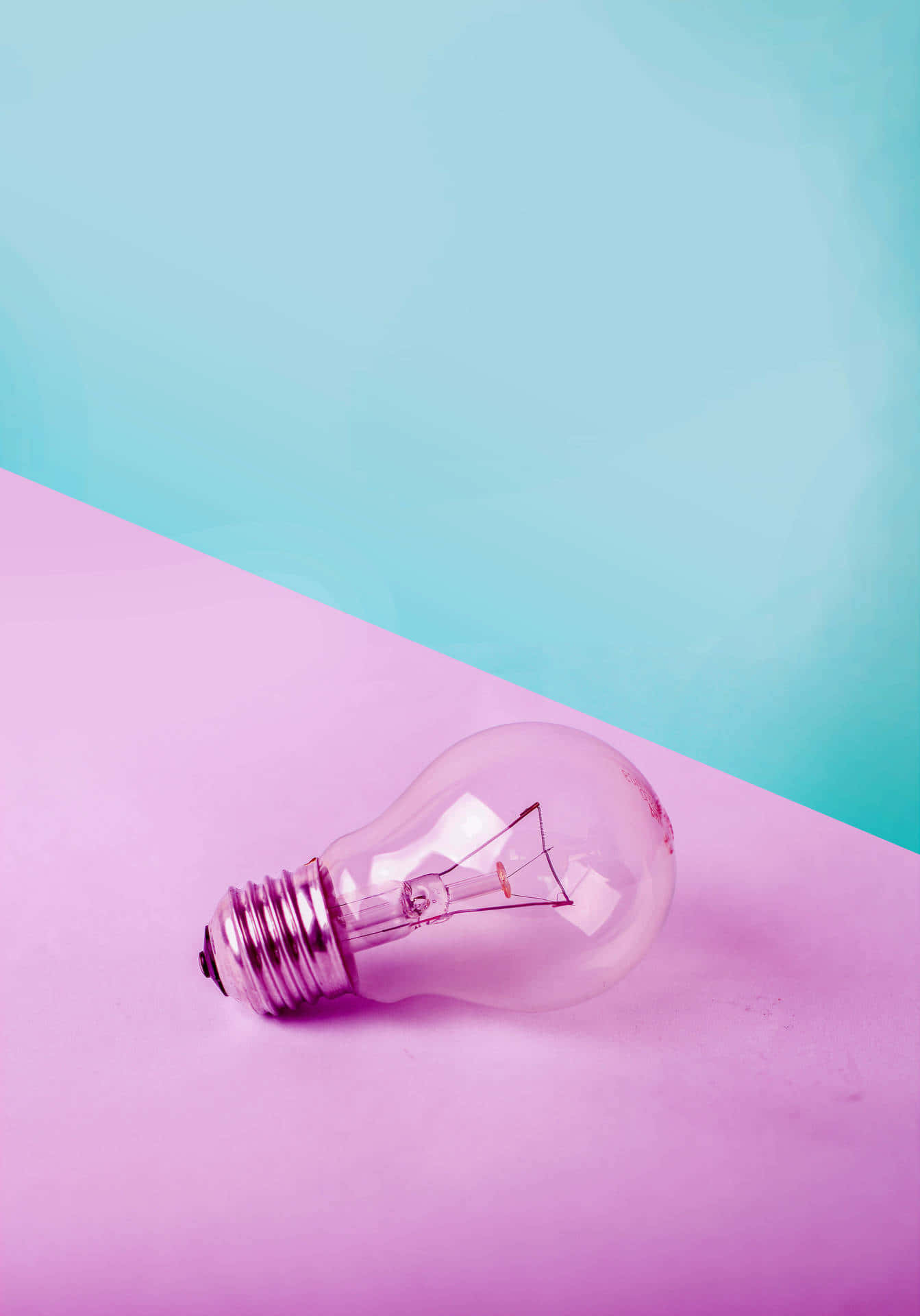 A Light Bulb On A Pink And Purple Background