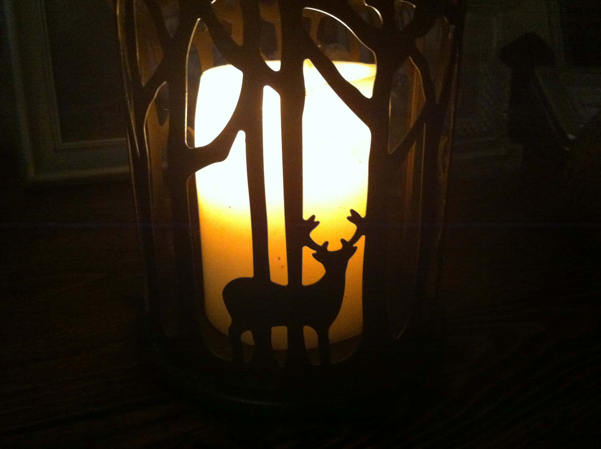 Solitary Candle Glowing In The Night Symbolizing Remembrance Wallpaper