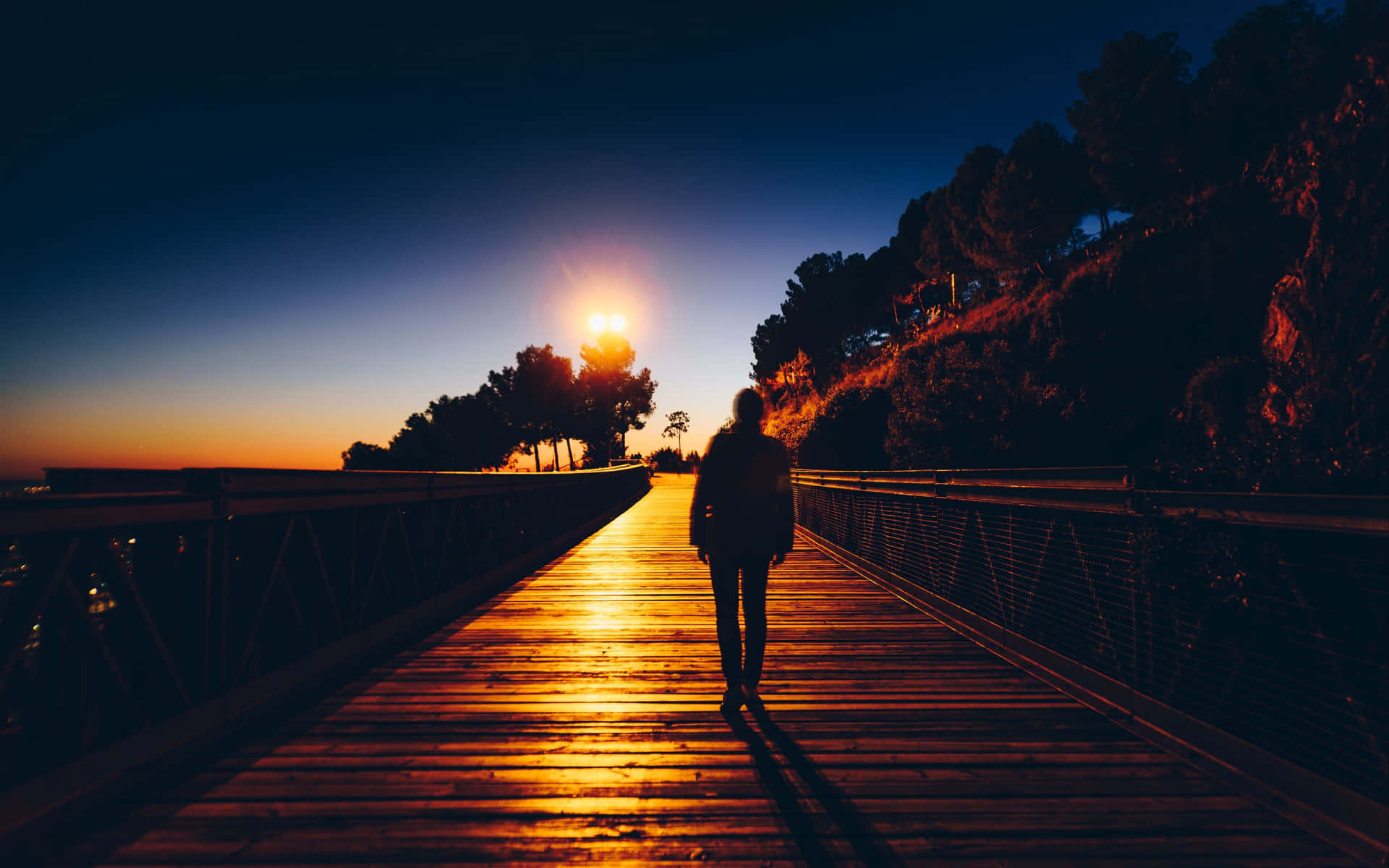 Solitary Man Walking In Sunrise Wallpaper