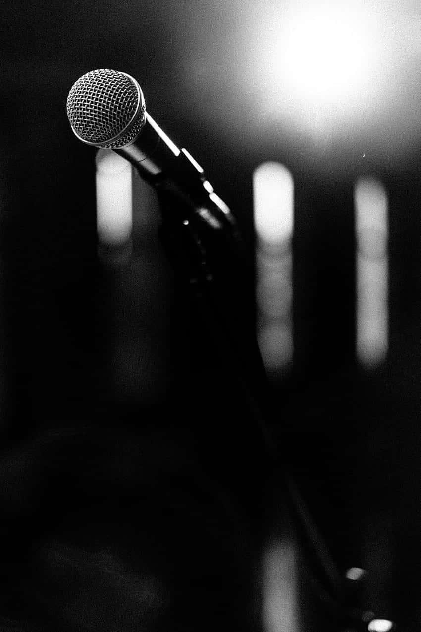 Solo Microphone Spotlight Blackand White Wallpaper