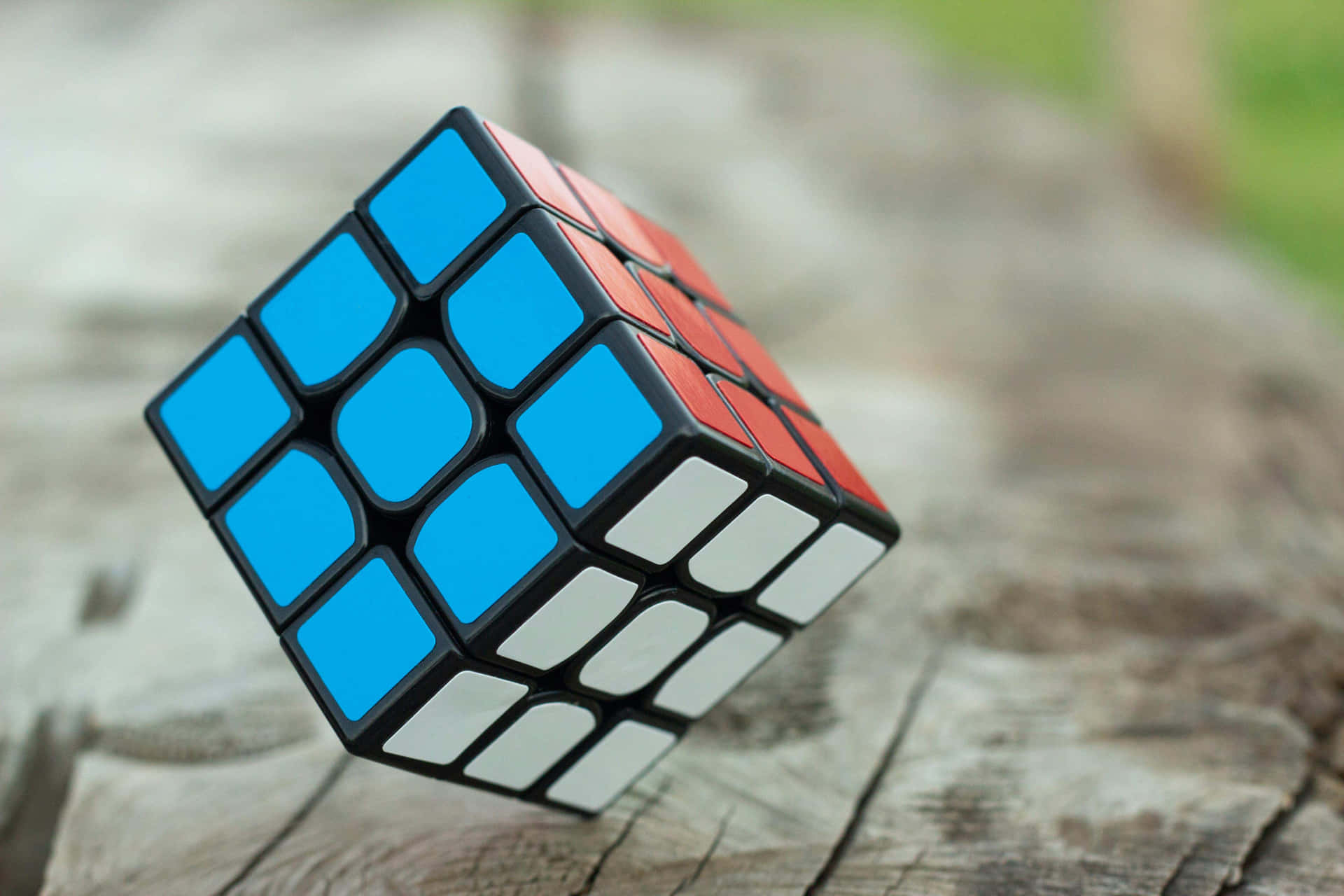 Solved Rubiks Cubeon Wooden Background Wallpaper