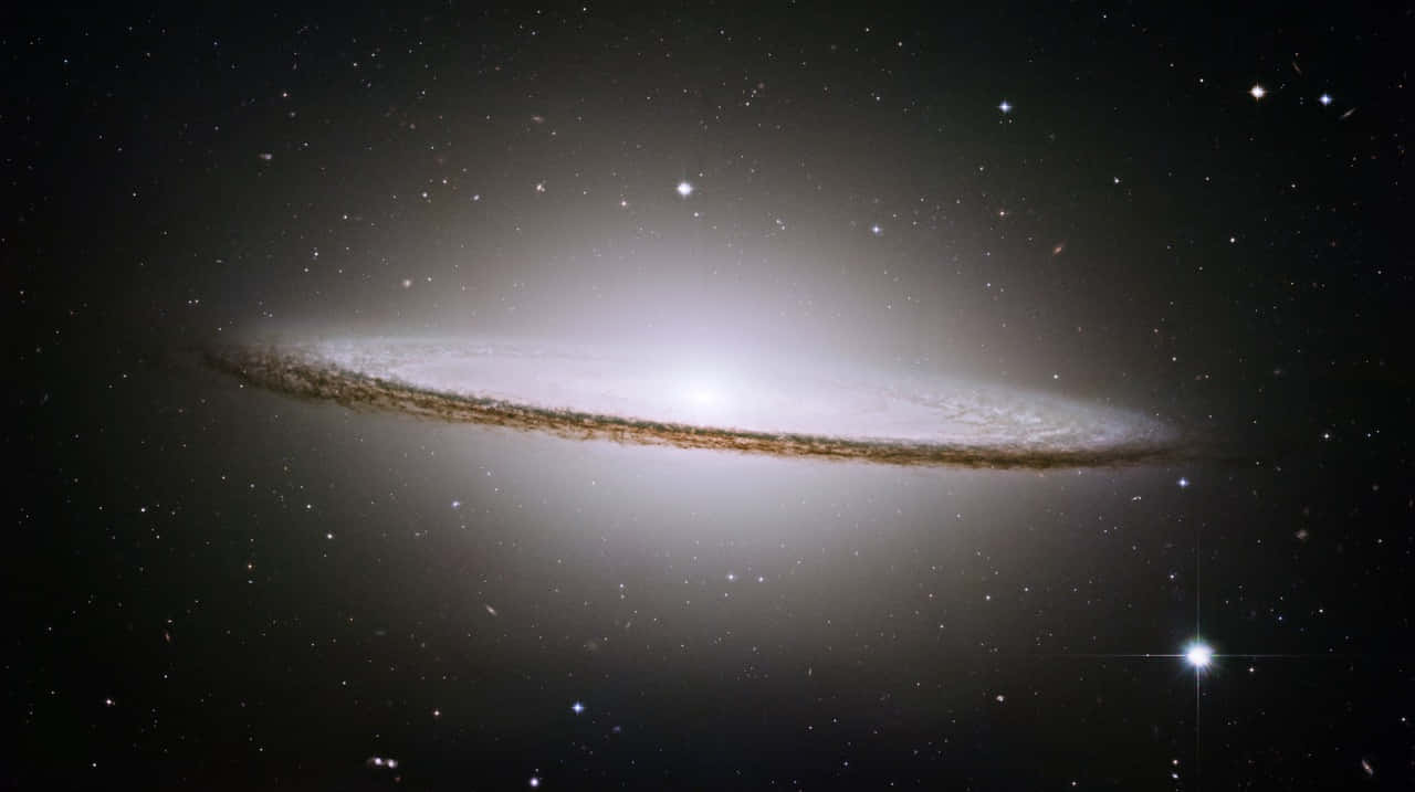 Caption: Majestic Sombrero Galaxy swirling in celestial wonder Wallpaper