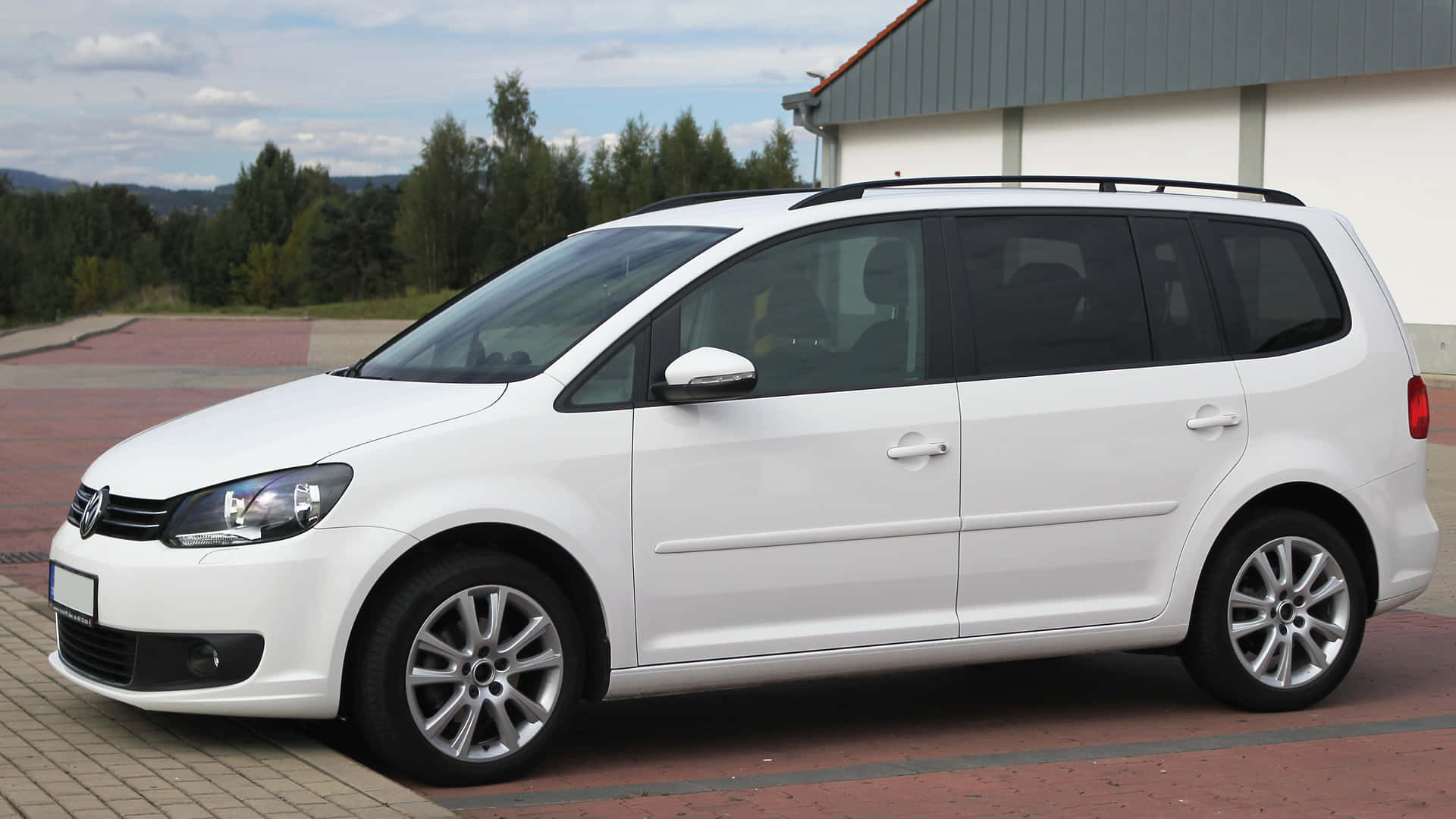 Sophisticated Volkswagen Touran On Urban Drive Wallpaper