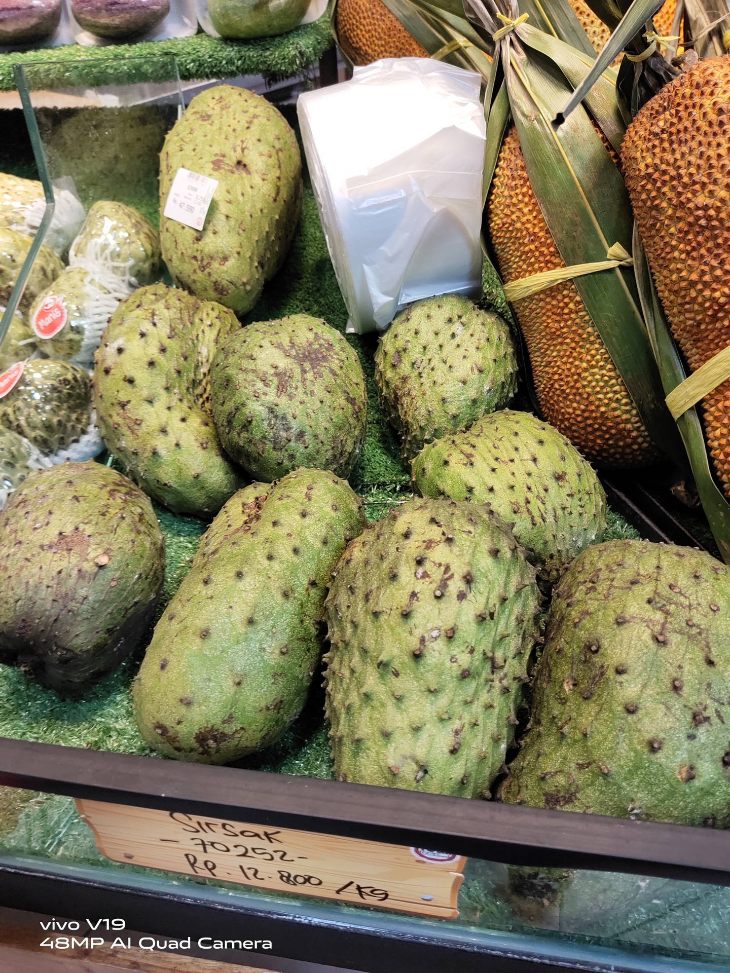 Fresh Soursop Fruits Displayed with Other Fruits at a Market Wallpaper