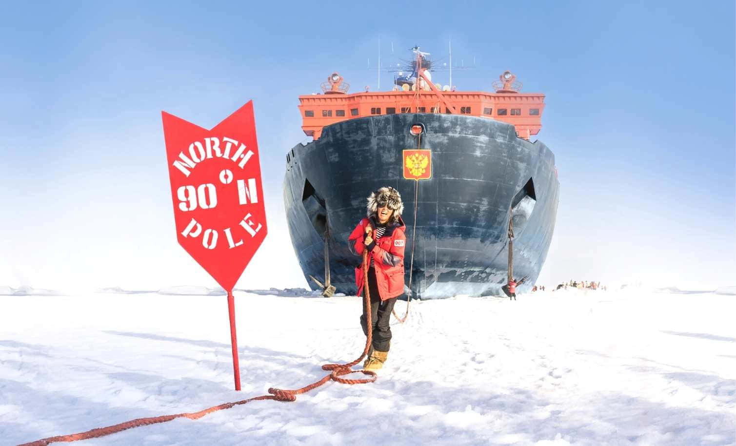 A Woman Is Standing Next To A Ship In The Snow