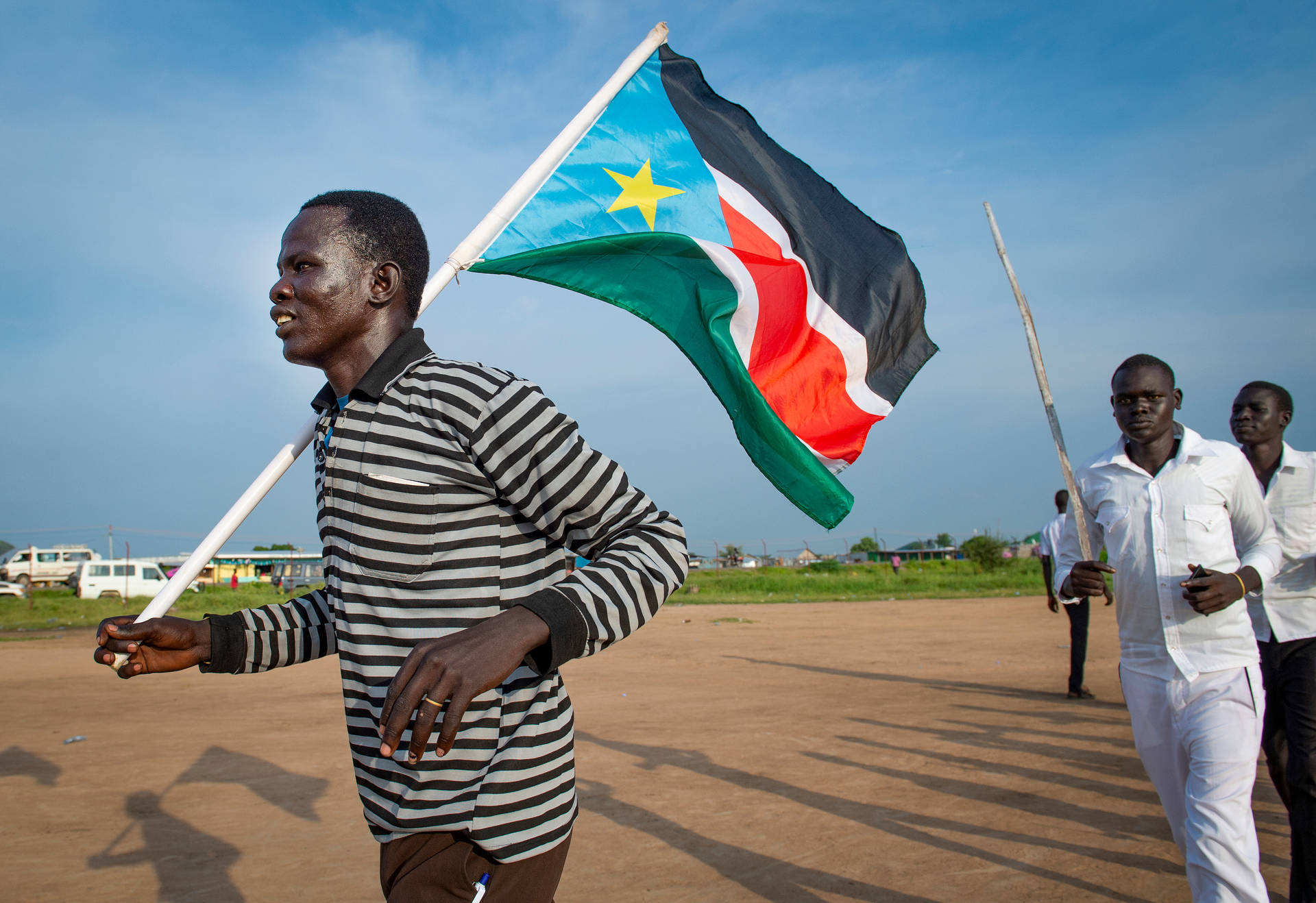 Caption: Proud South Sudan Man Holding National Flag Wallpaper