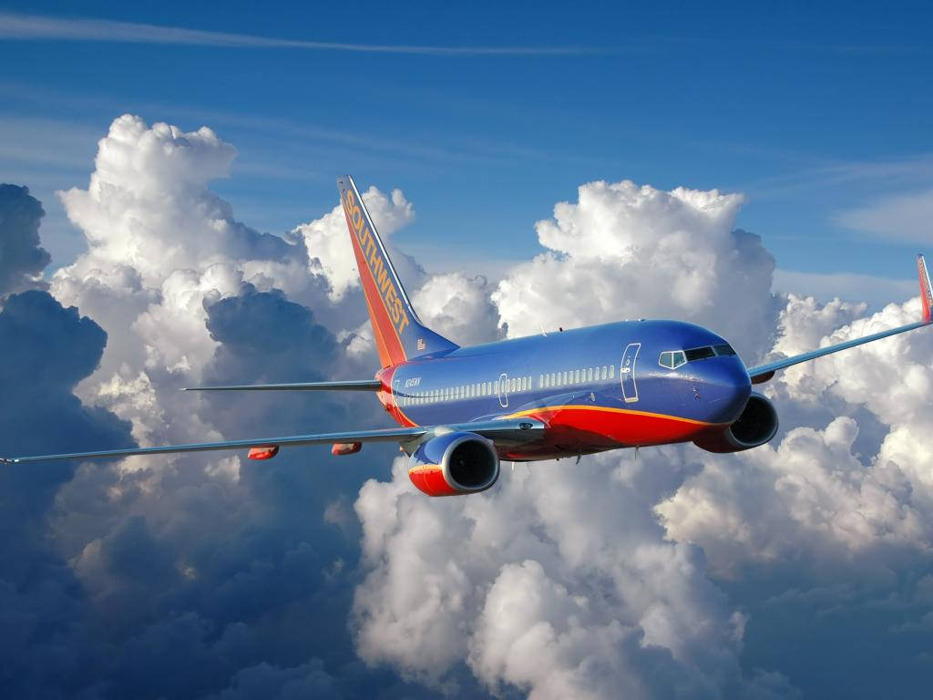 Southwest Airlines Airplane In Sea Of Clouds Background