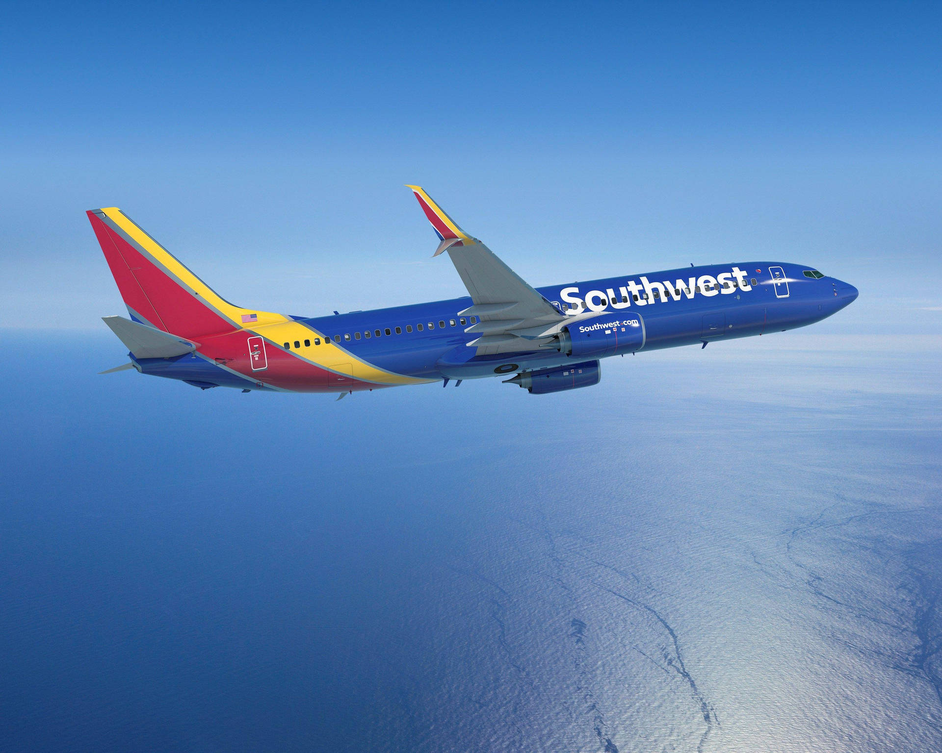 Southwest Airlines Flyvemaskine over Ocean Scene Wallpaper