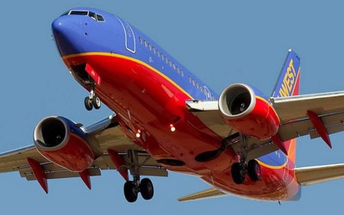 Southwest Airlines' Fleet Soaring In The Vibrant Sunset Sky Wallpaper