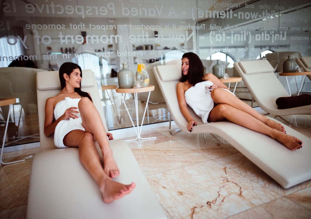 Two Women Sitting On Spa Chair Picture