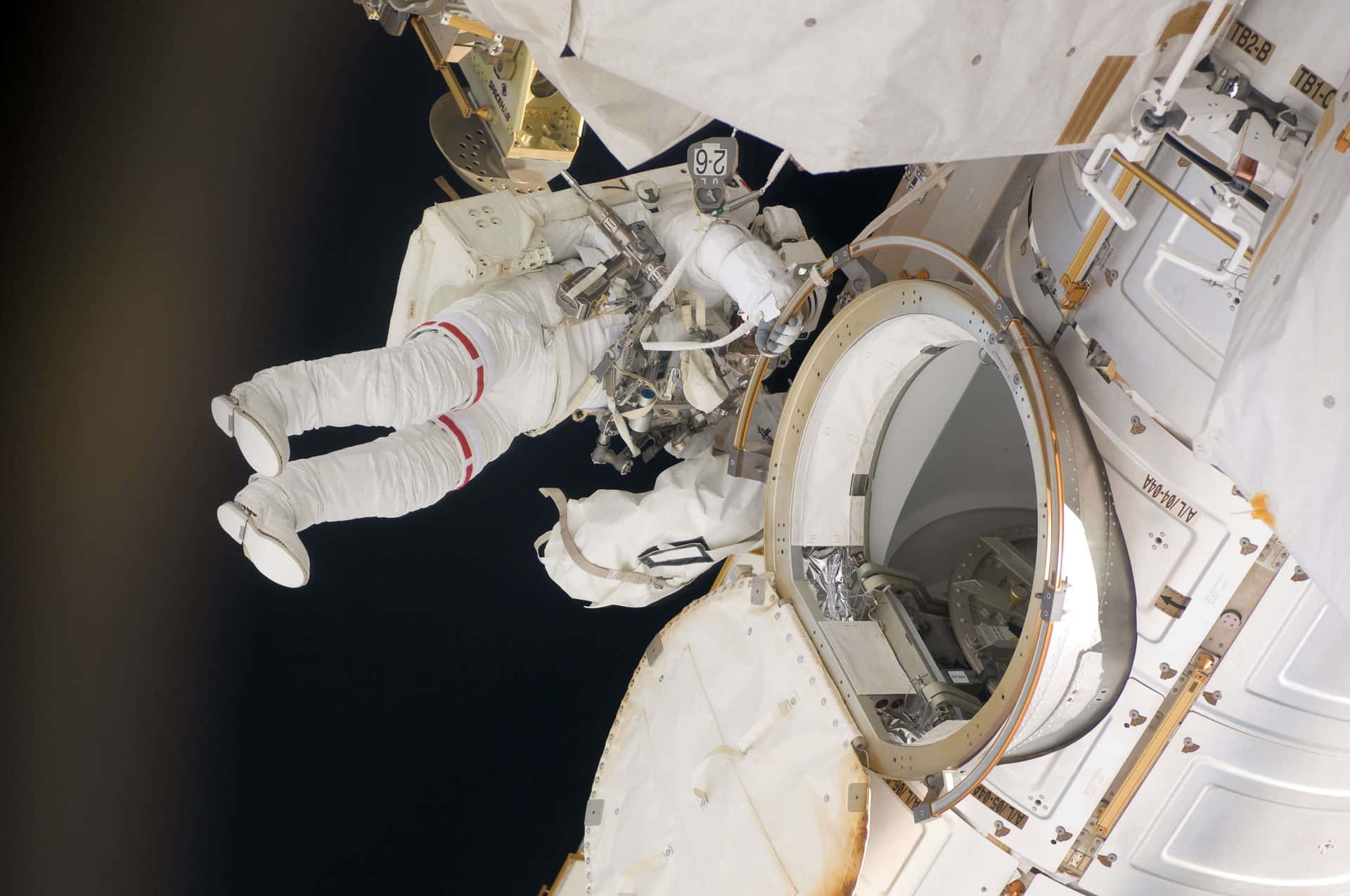 Astronaut performing a spacewalk on a space mission Wallpaper