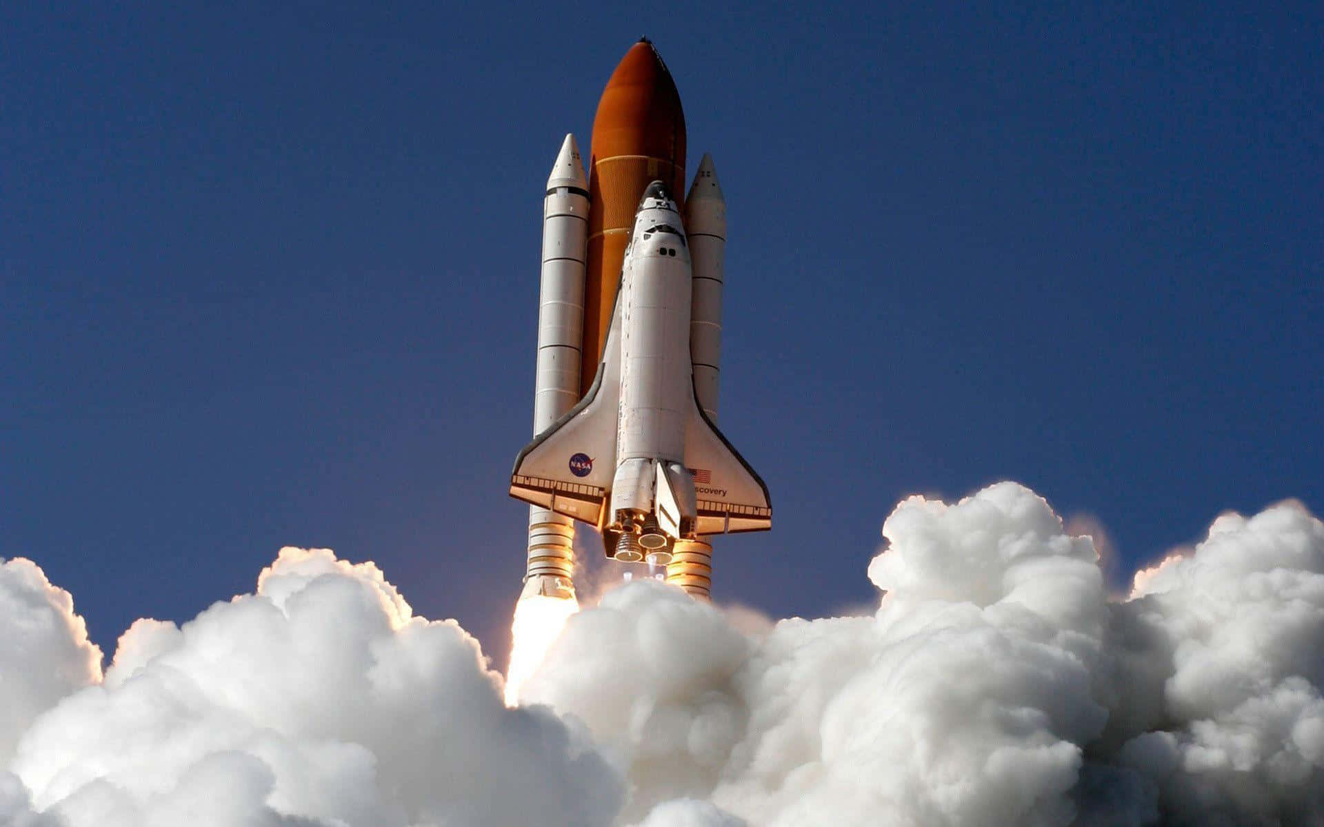 “The space shuttle Discovery flies through the sky in a bright and sunny day” Wallpaper