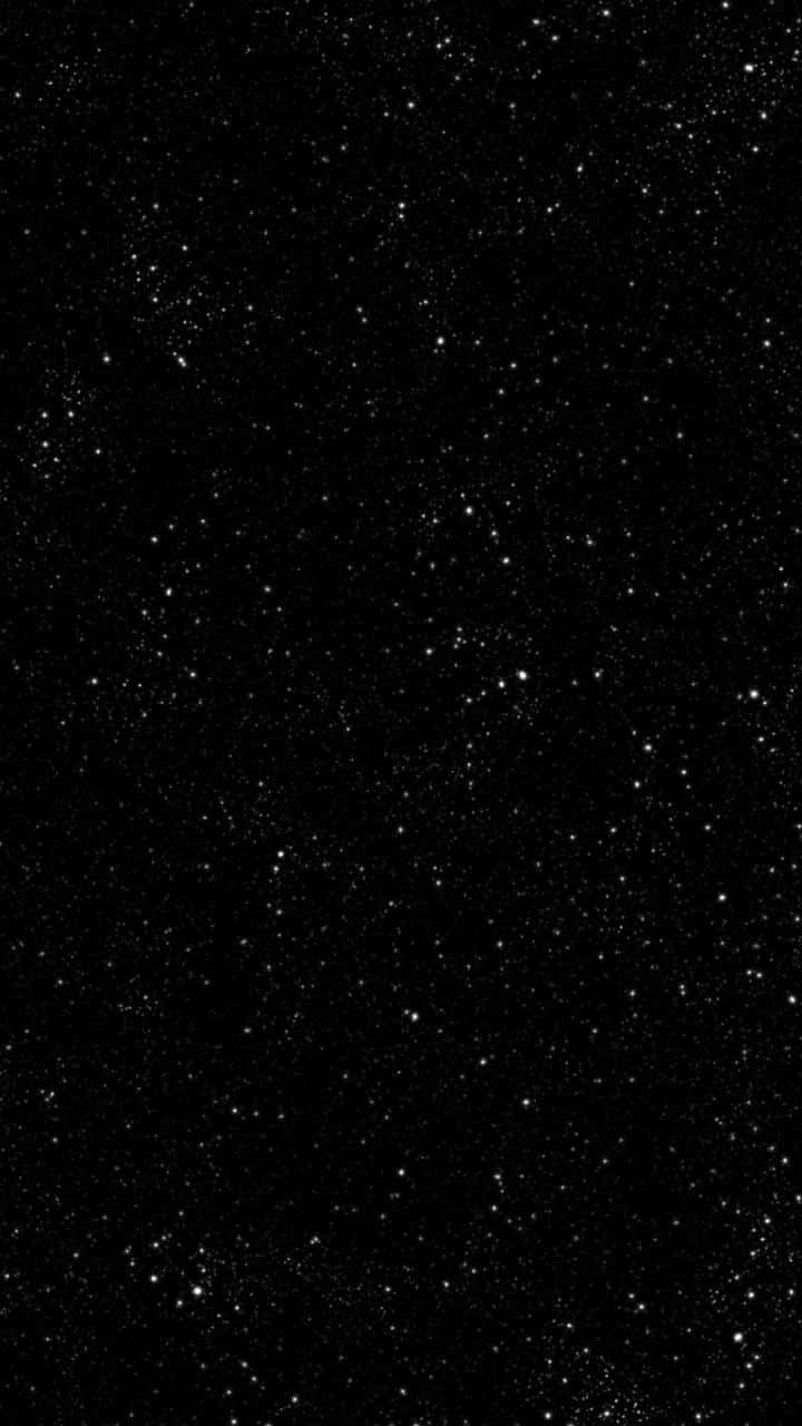 En sort baggrund med stjerner på den. Wallpaper