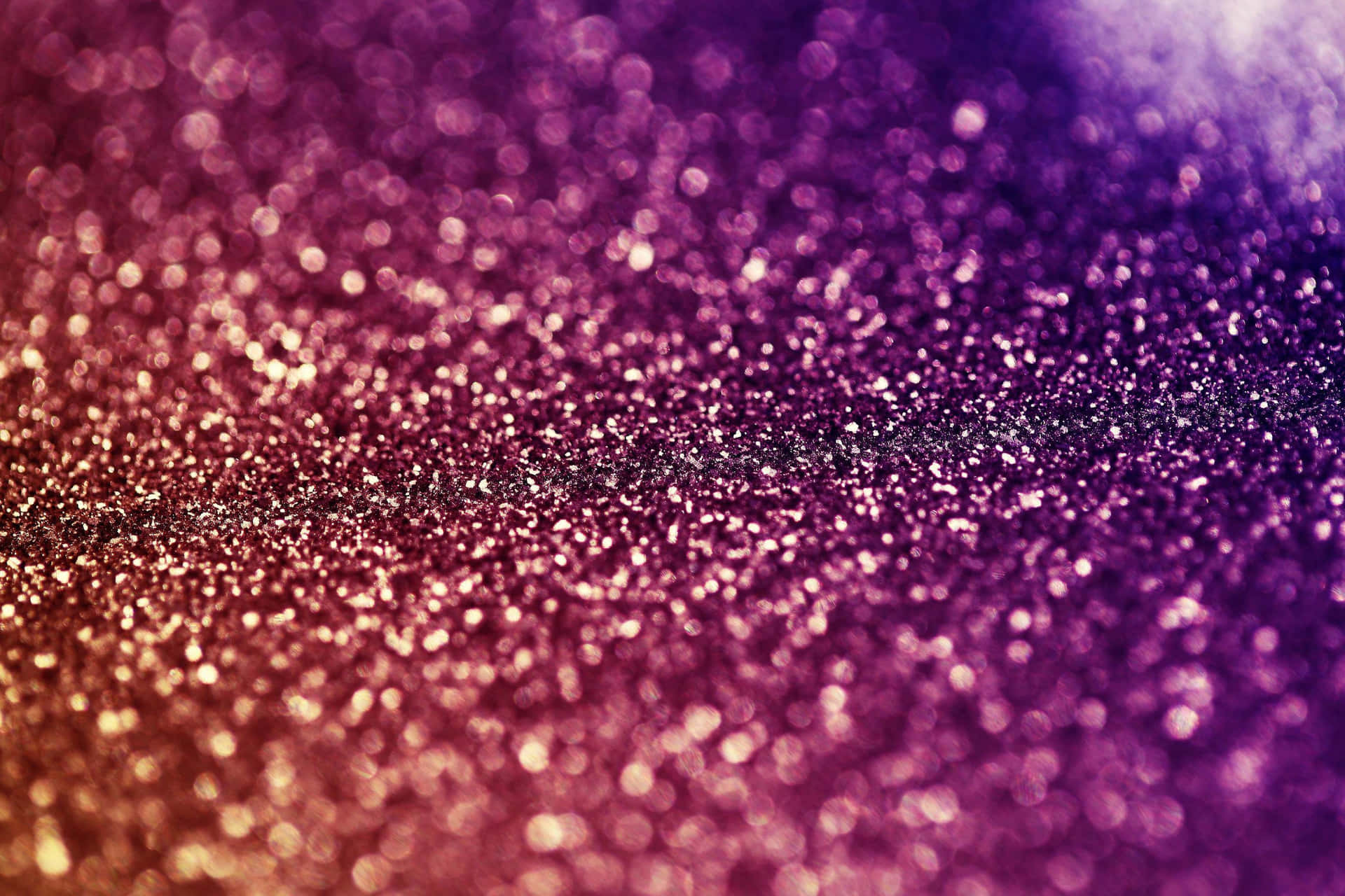 A Purple And Gold Glitter Background