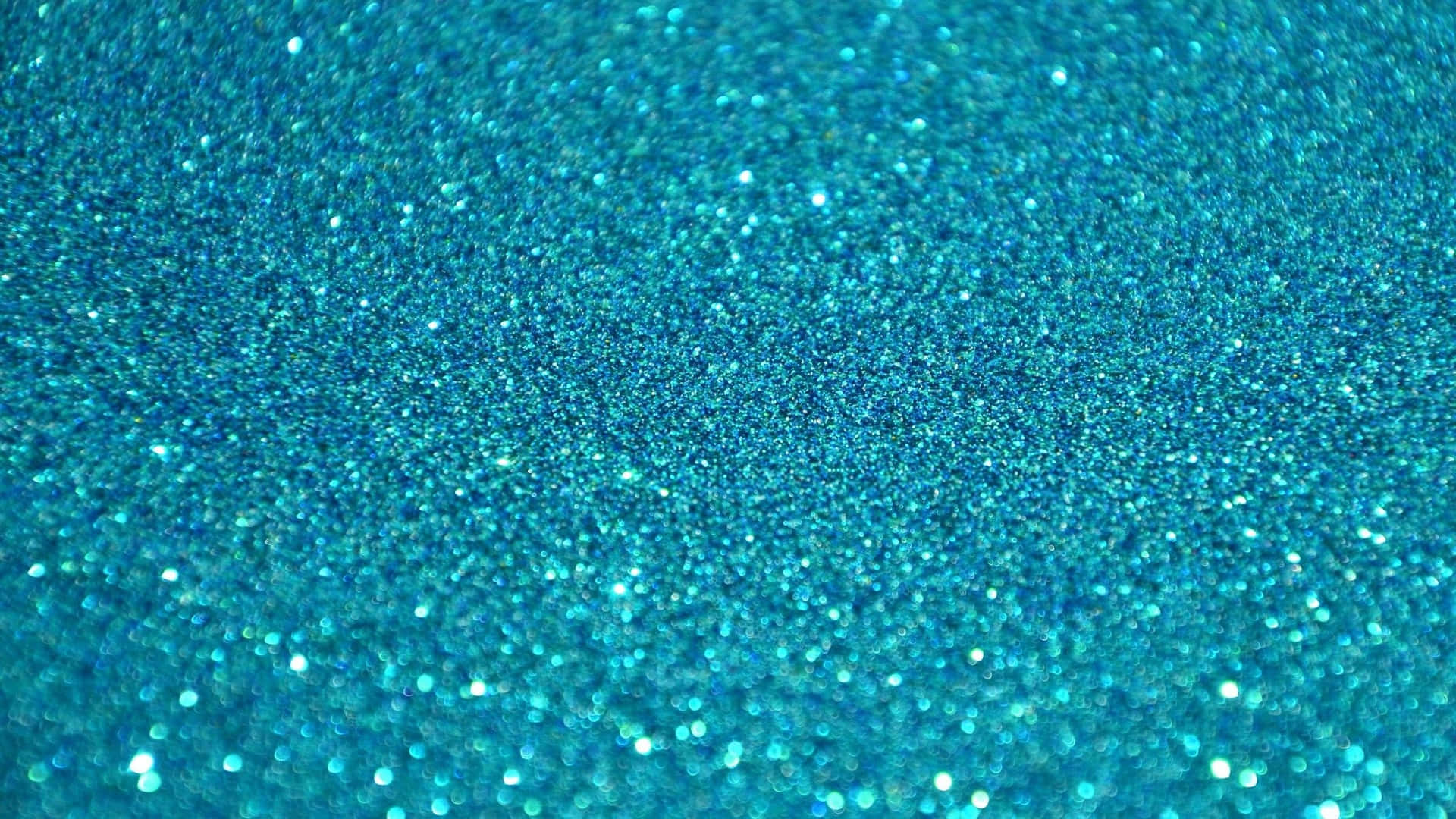 a close up of a turquoise glitter background