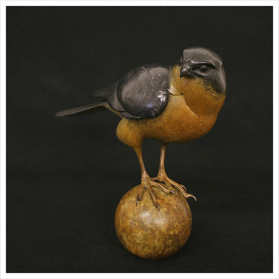 A Bird Is Sitting On A Wooden Ball