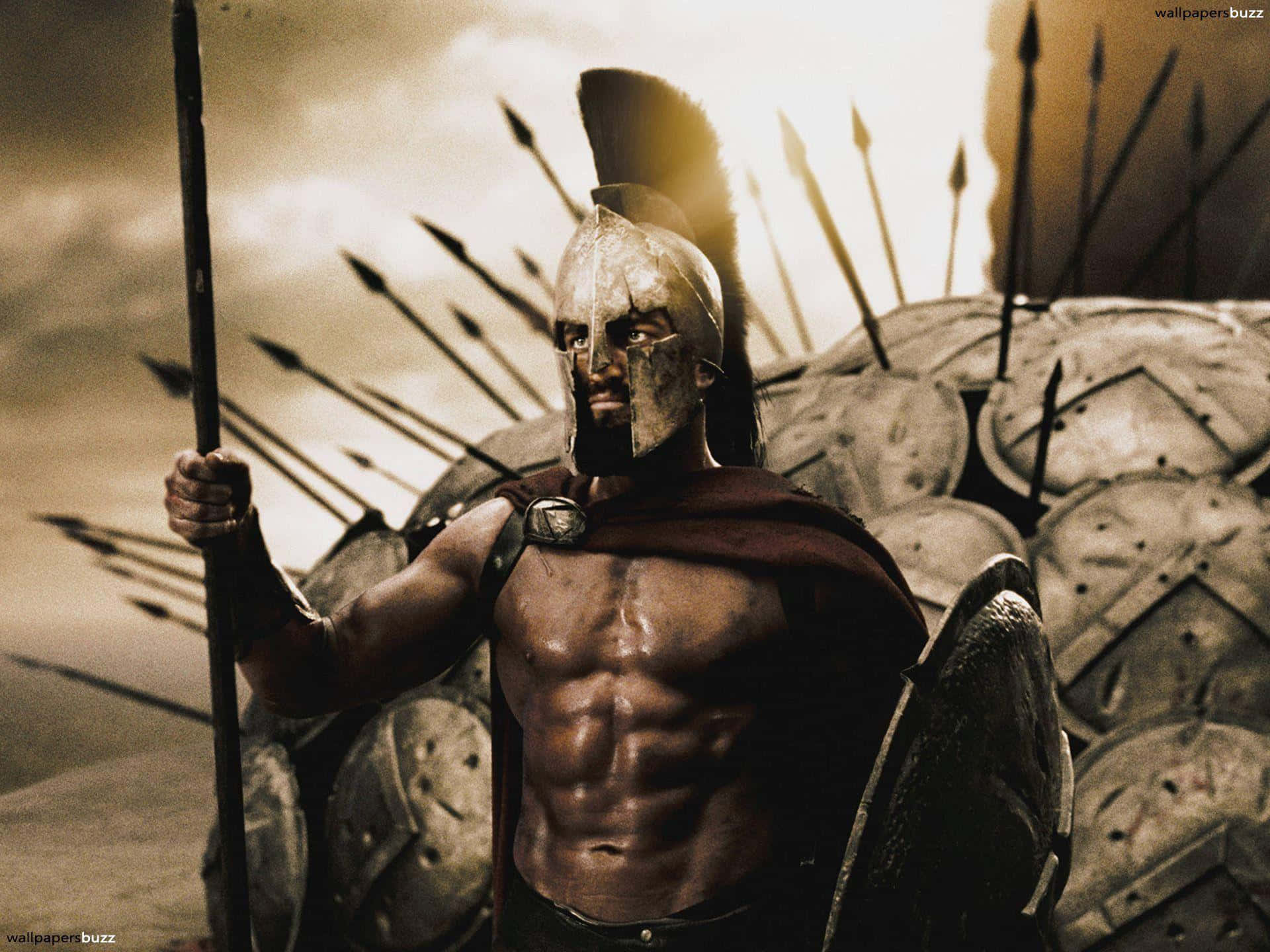 En modig spartanersoldat står øverst på en bakke i en klassisk stilling, klar til at tage imod enhver udfordring. Wallpaper