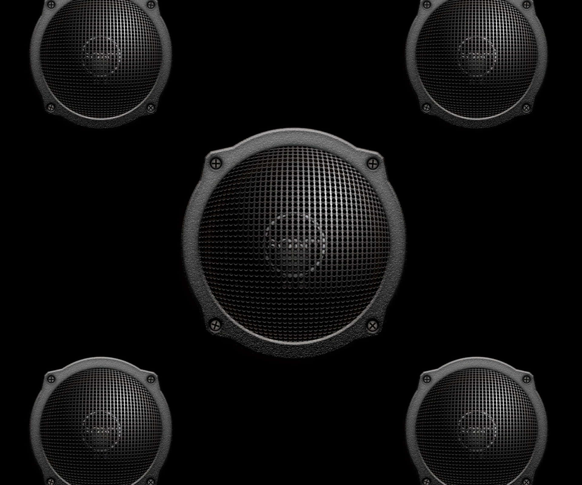Close-up view of a professional black audio speaker on a bright white background