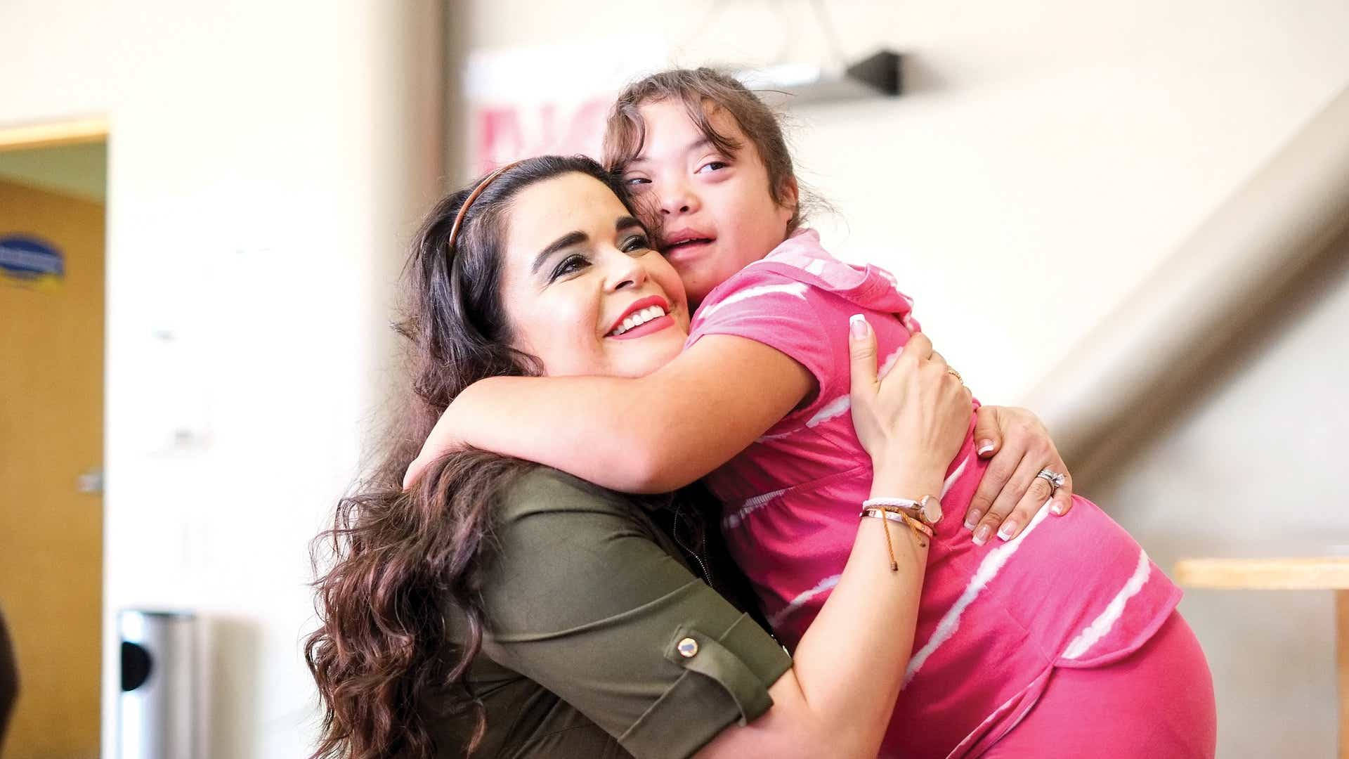 Special Child Student Hugging Her Teacher Wallpaper