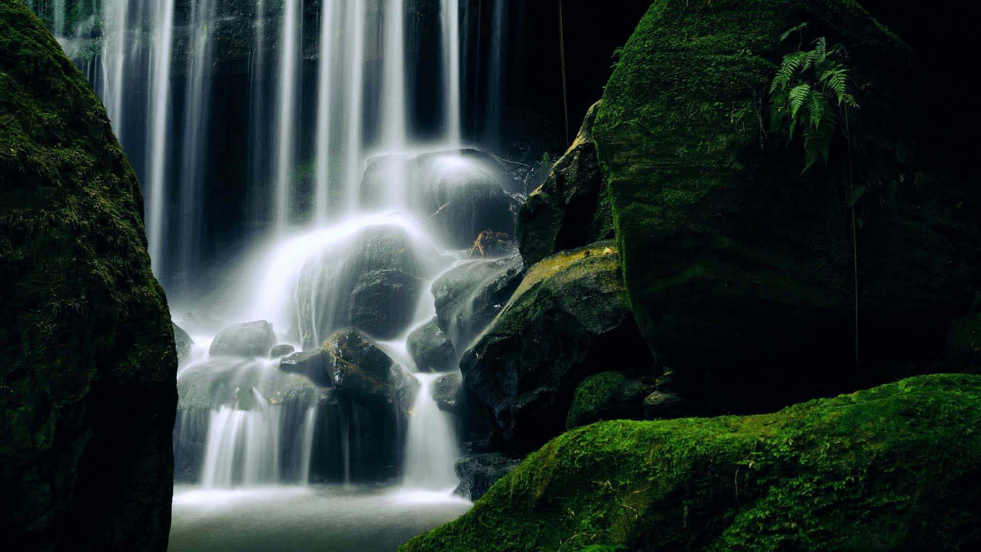 Spectacular 4k Image Of A Lush Waterfall Wallpaper