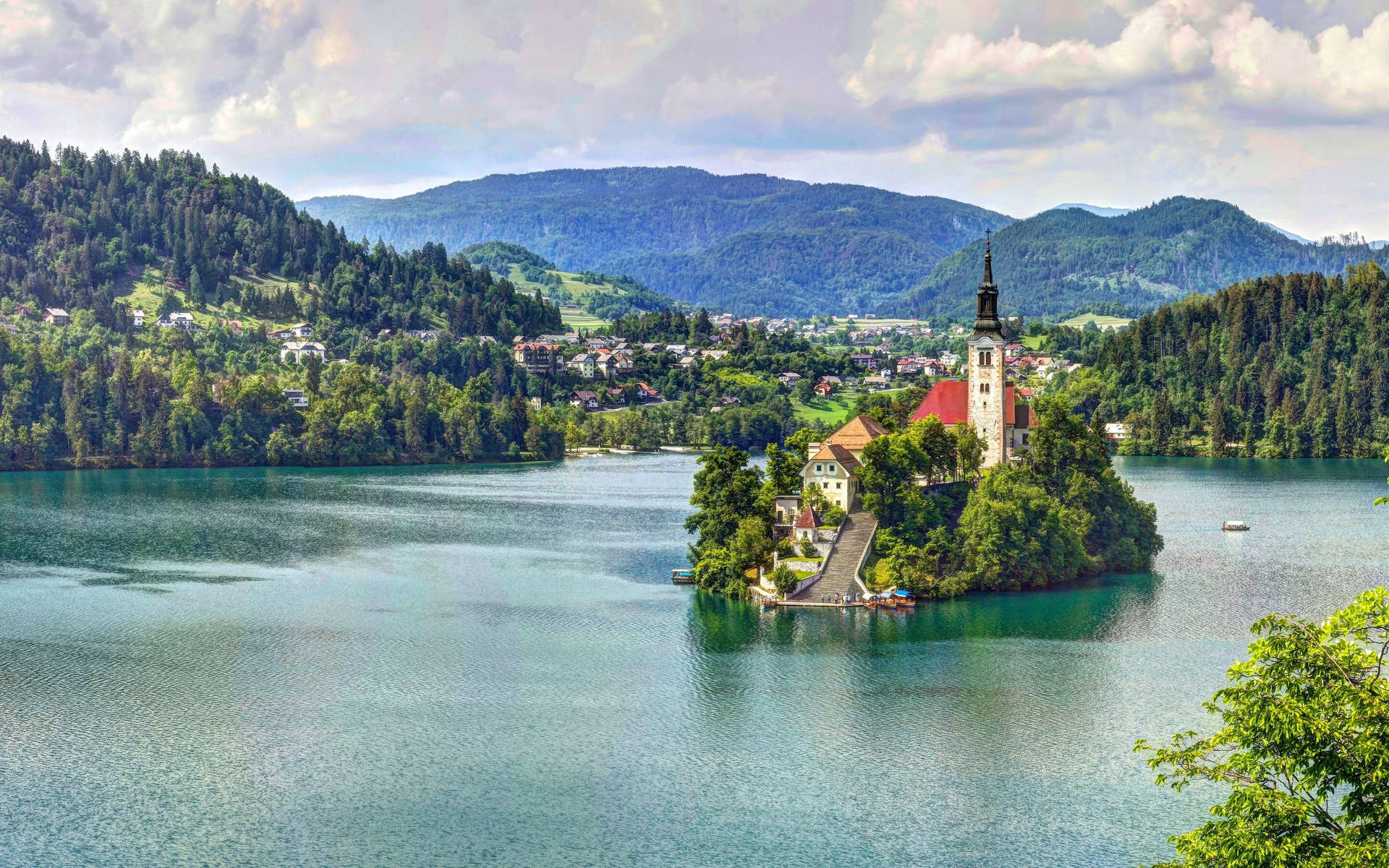 Spectacular Lake Bled Surrounded By Majestic Mountains Wallpaper
