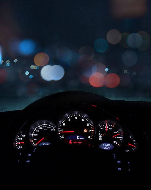 SpeedTest Display on a Car Dashboard at Night Wallpaper