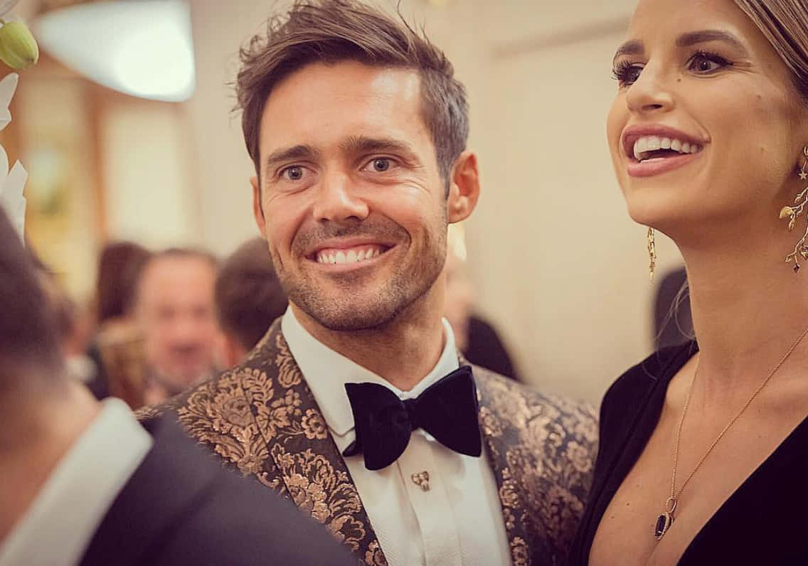 Caption: Spencer Matthews at an event, smiling and looking dapper. Wallpaper