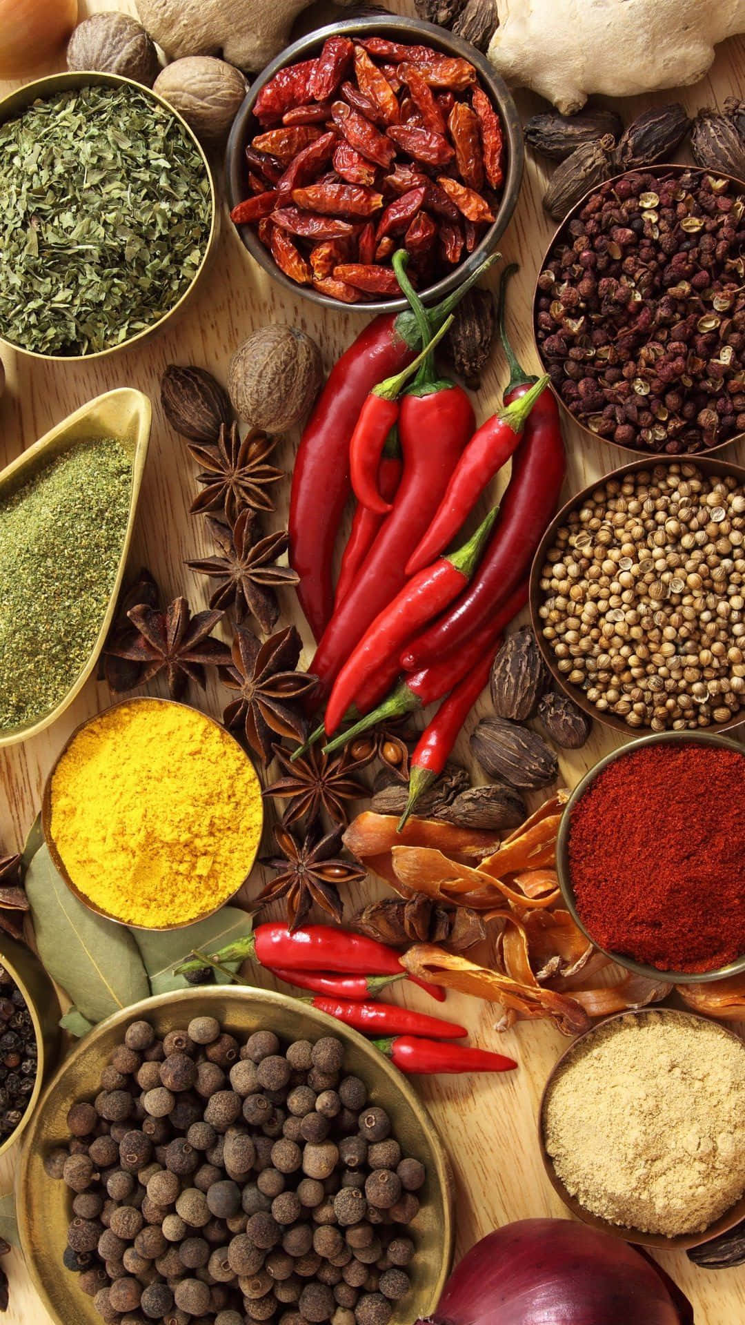 Various Spices And Herbs Are Arranged On A Wooden Table
