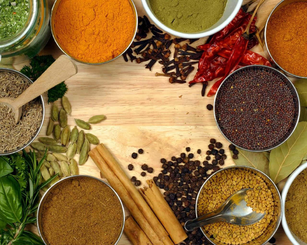 A Variety Of Spices And Herbs On A Wooden Table