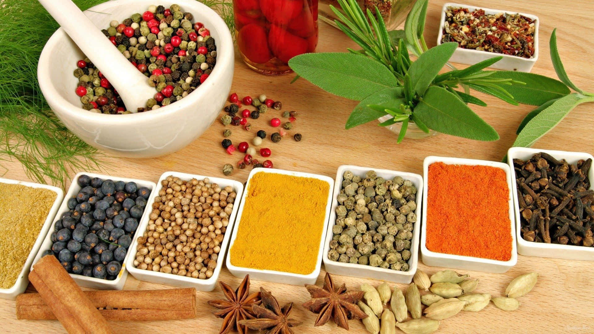 Various Spices And Herbs On A Wooden Table