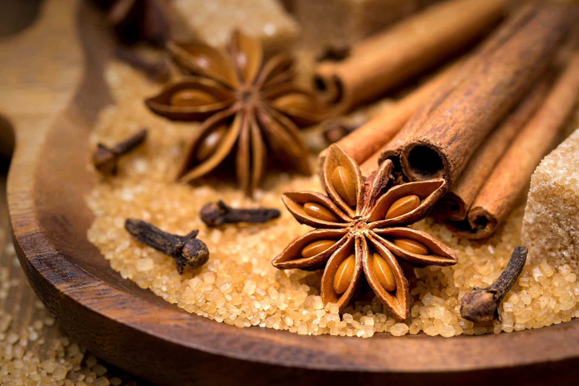 Cinnamon, Sugar, And Star Anise In A Wooden Bowl