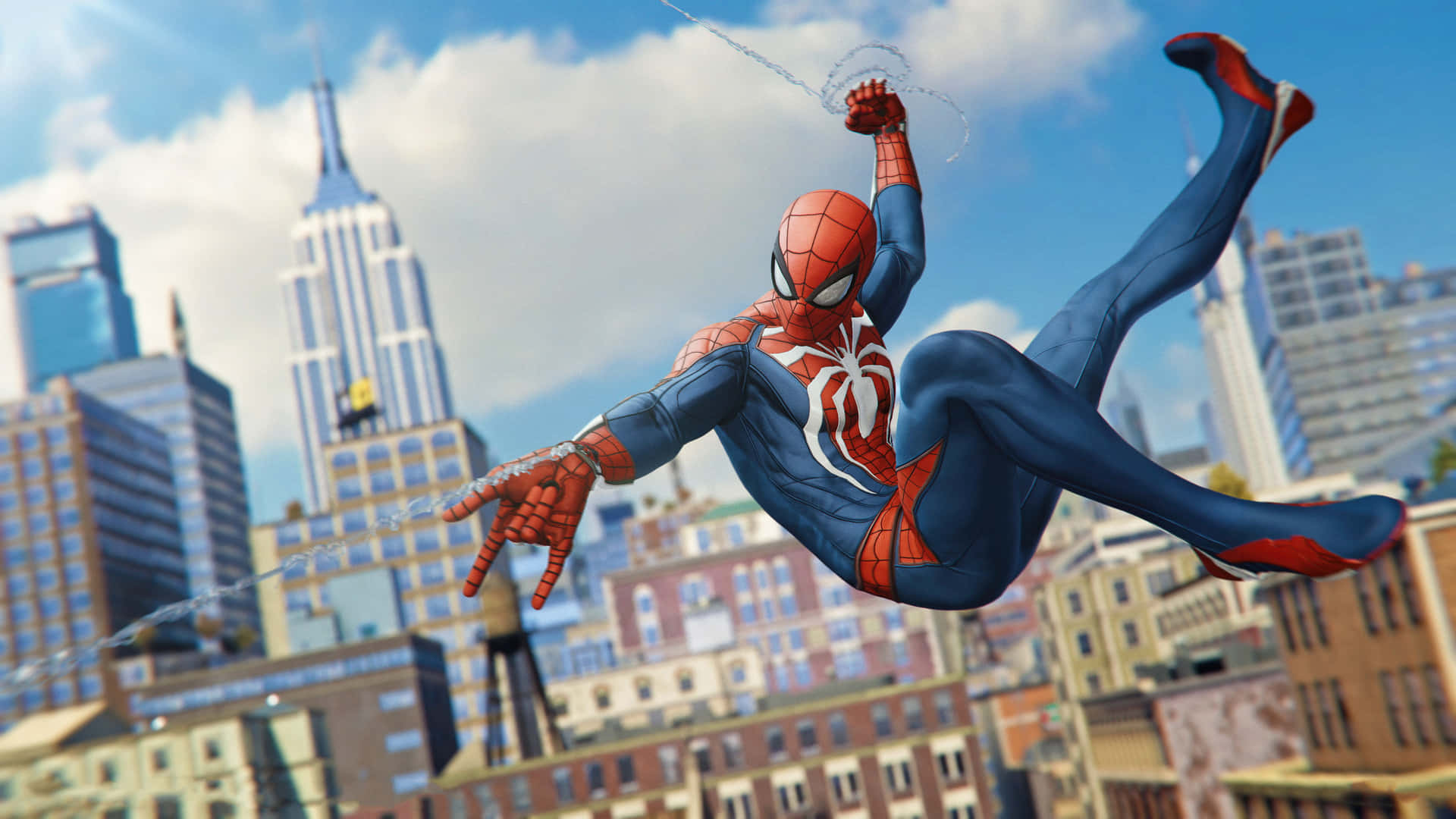 Spider-Man gracefully swings through the city Wallpaper