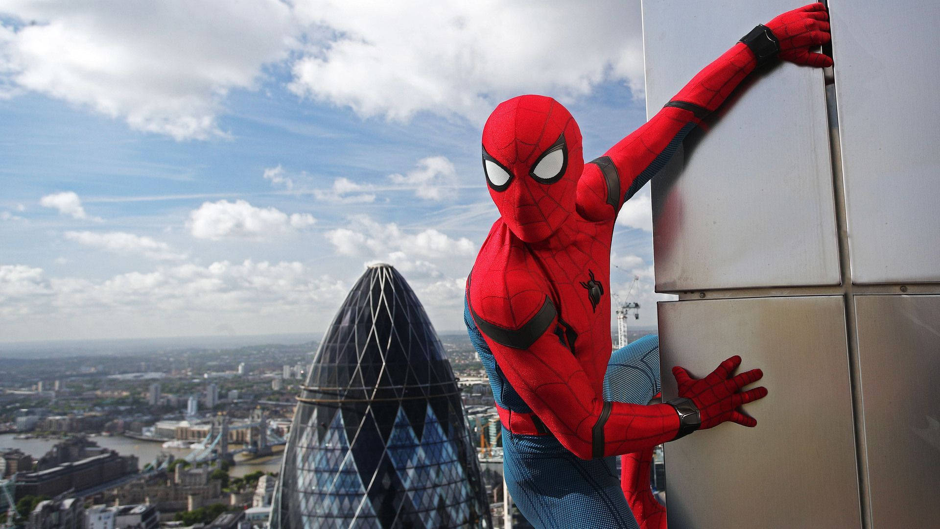 Spiderman swinging in front of the Gherkin Tower Wallpaper