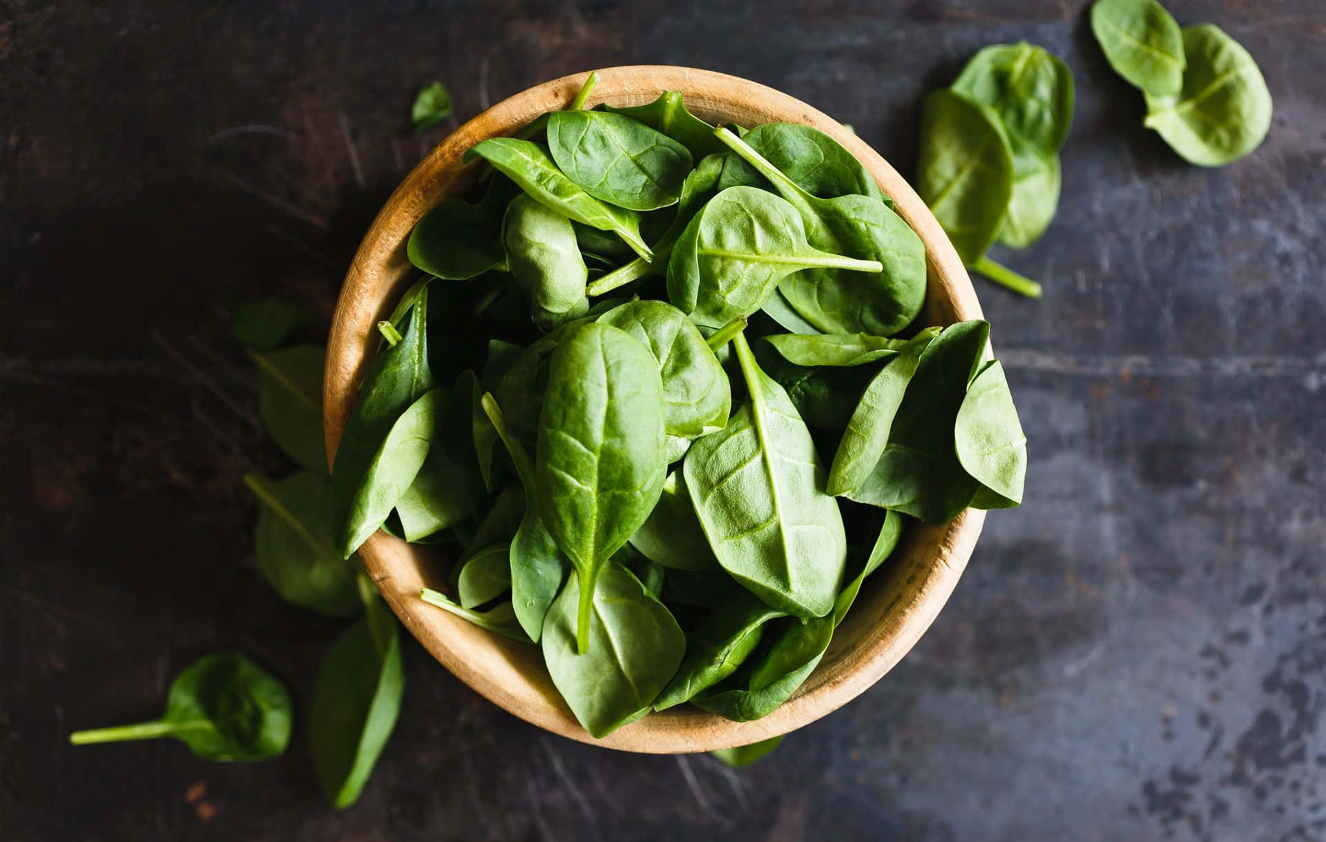 Fresh Spinach Leaves in a Wooden Bowl Wallpaper
