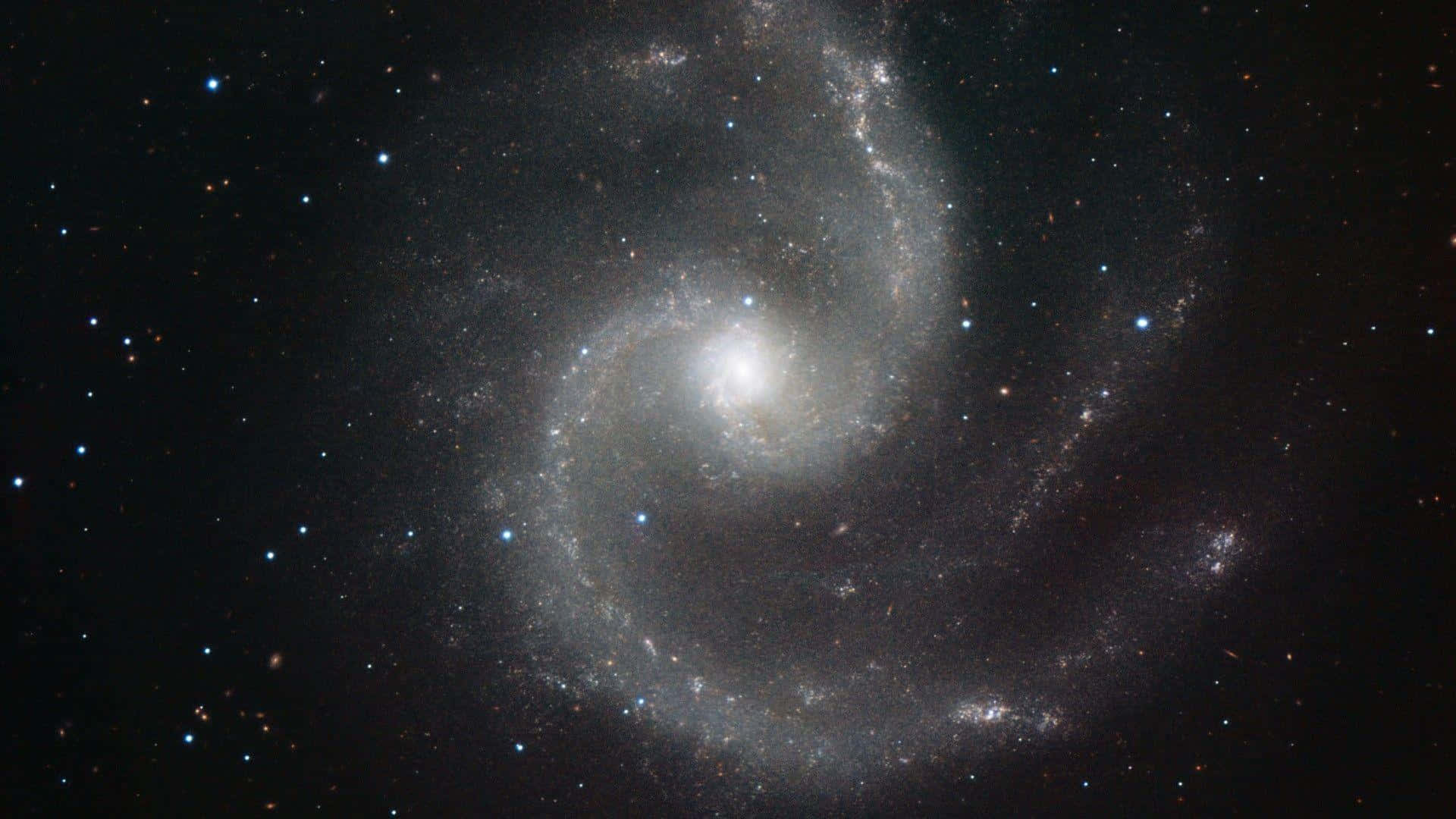 Mesmerizing Spiral Galaxy Illuminating the Night Sky Wallpaper