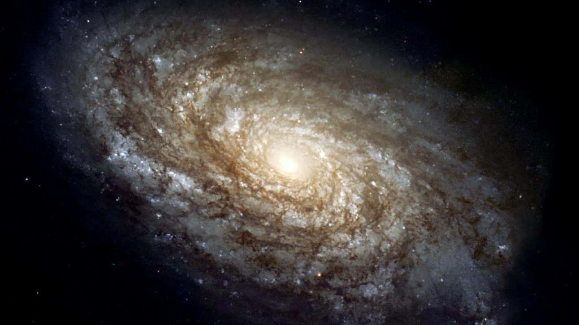 Majestic Spiral Galaxy Unfolding in Deep Space Wallpaper